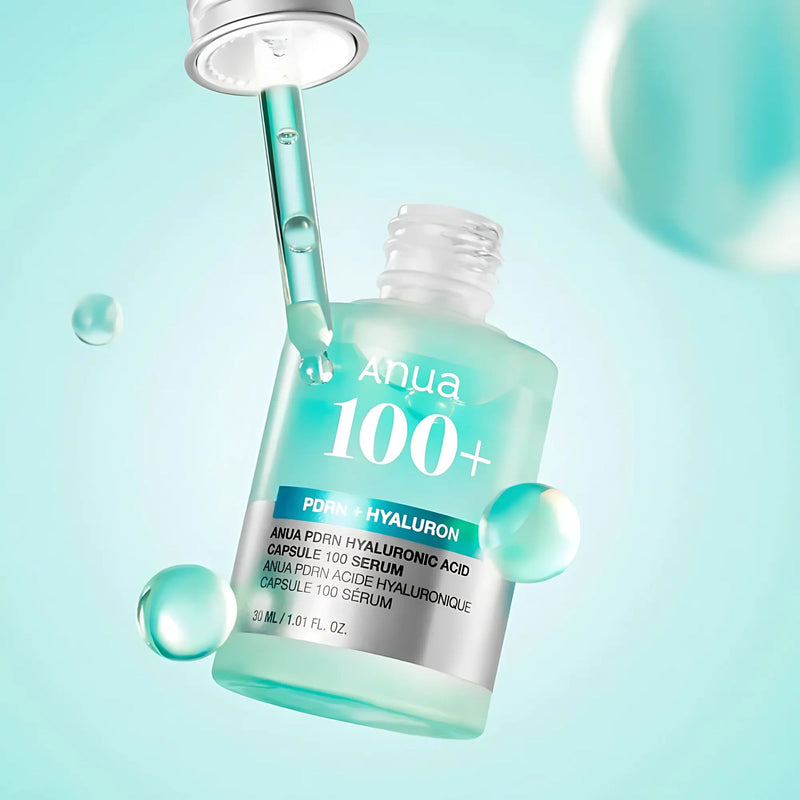Anua 100+ serum bottle with dropper on a light blue background