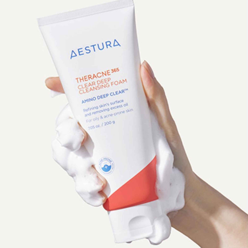 Aestura Theracne 365 Clear Deep Cleansing Foam with a hand holding the product against a white background
