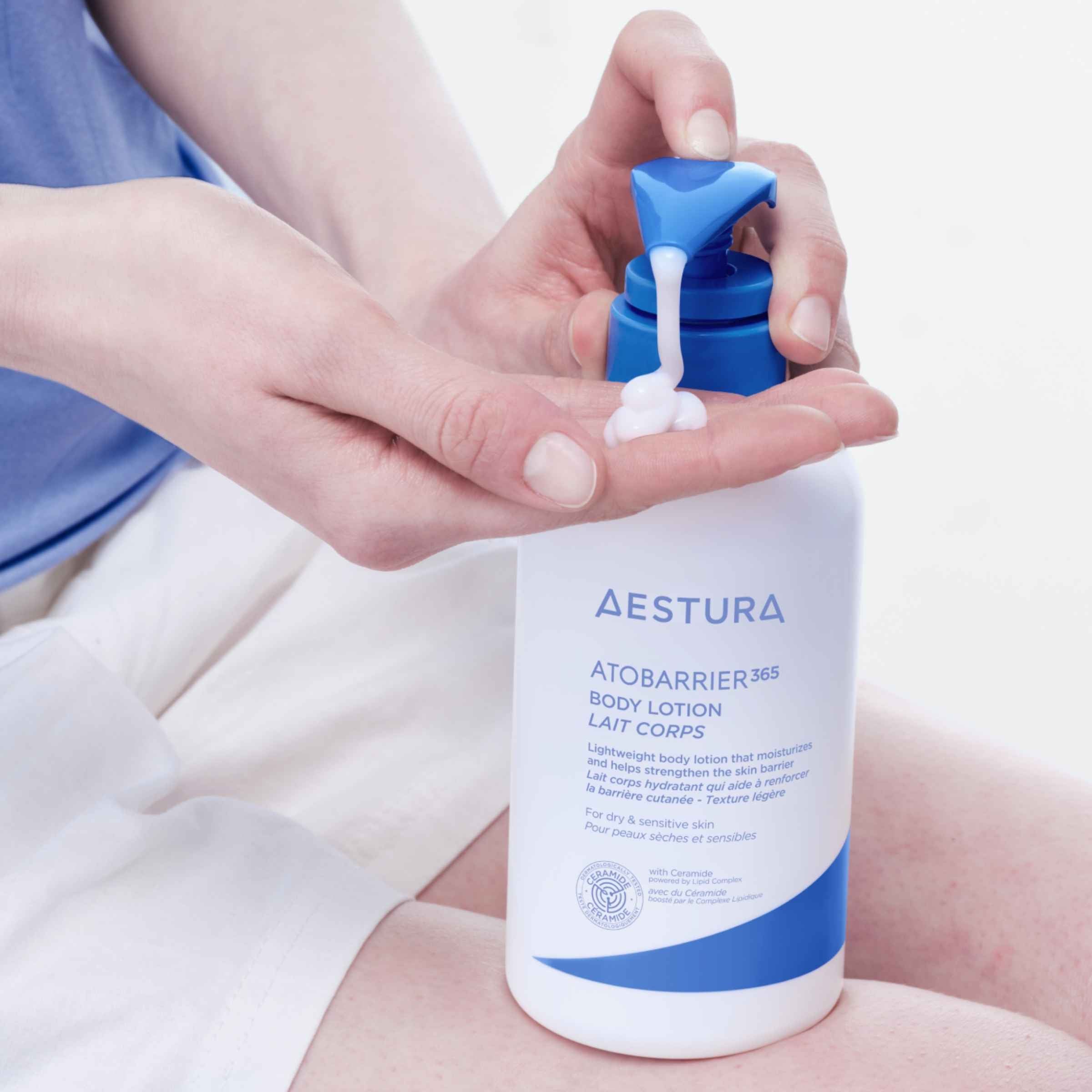 Person applying Aestura Atobarrier 365 body lotion to their hand.