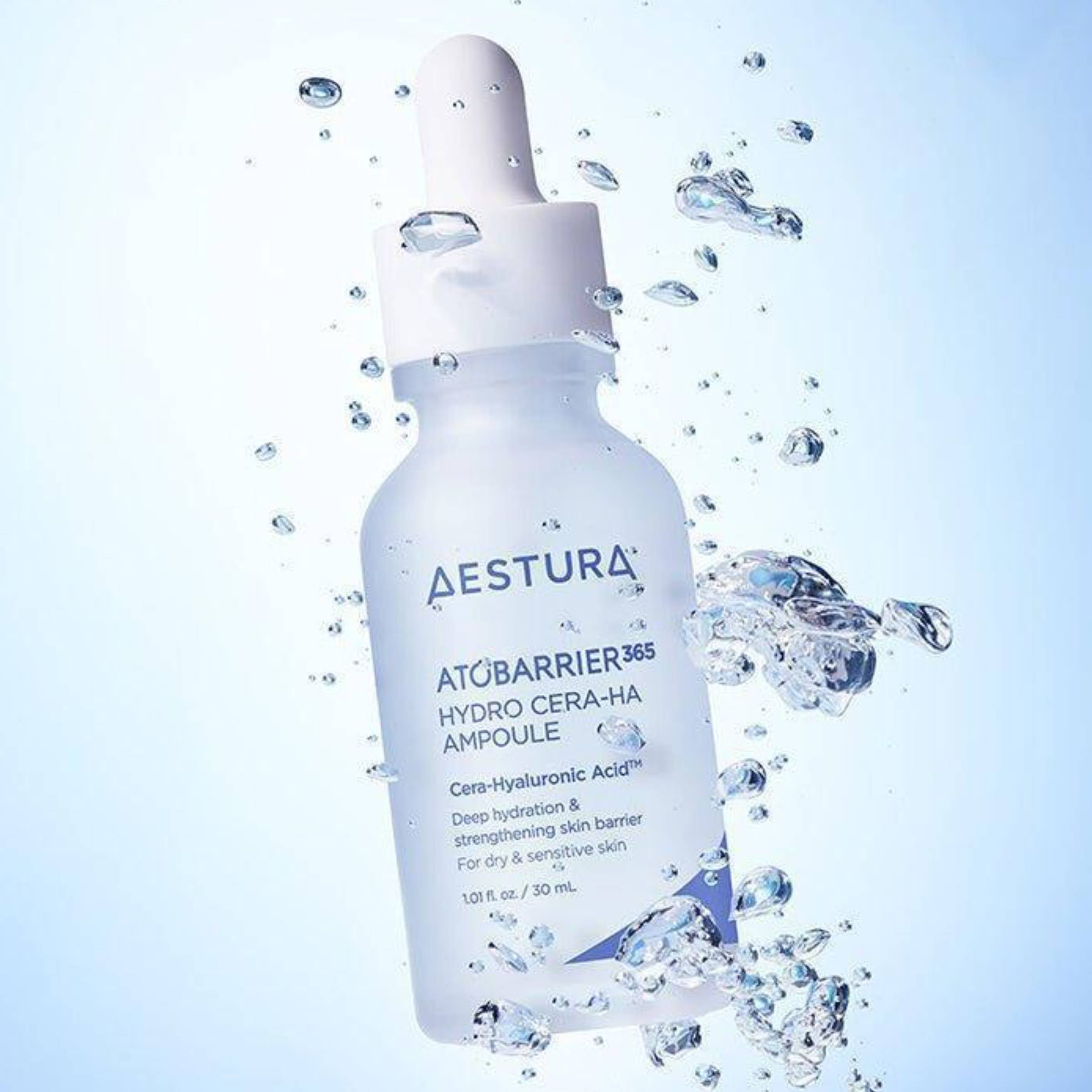 Aestura Atobarrier 355 Hydro Cera-Ha Ampoule bottle with water droplets on a light blue background