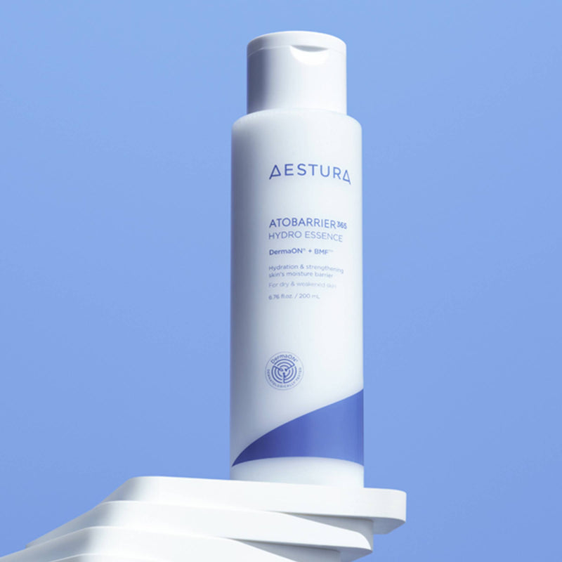 Aestura skincare bottle on a blue background