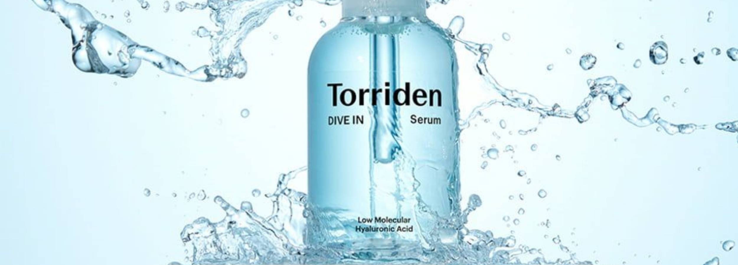 Torriden serum bottle with water splashes on a light blue background