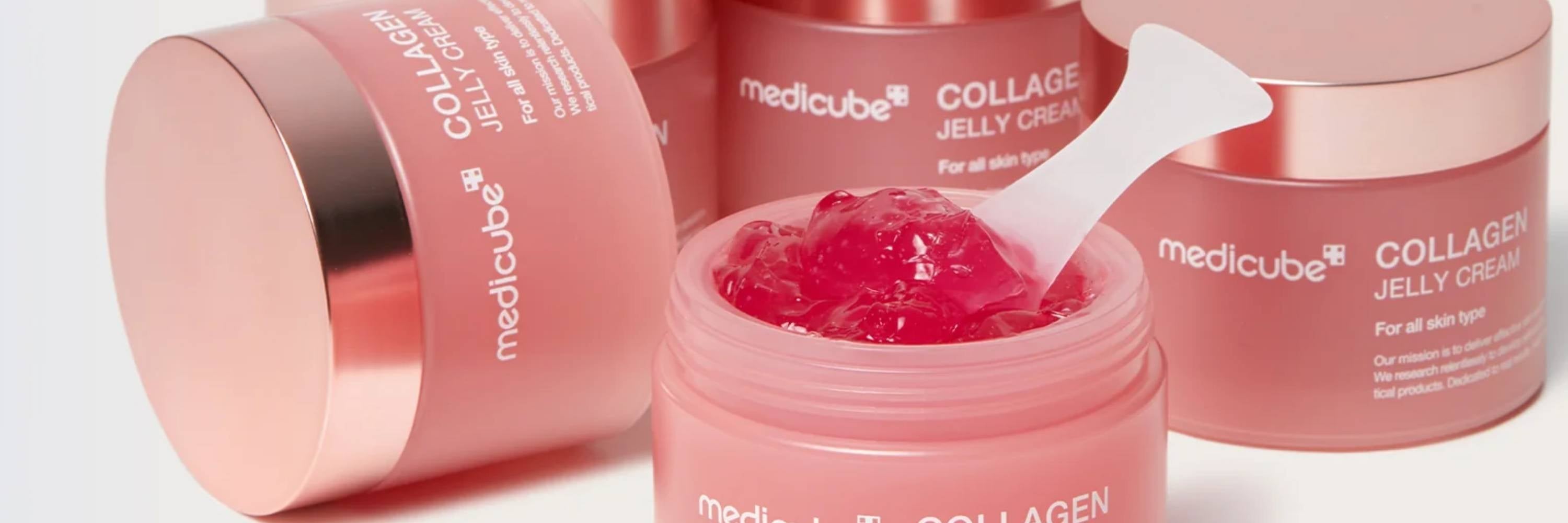 Pink jars of Medicube Collagen Jelly Cream with a white background