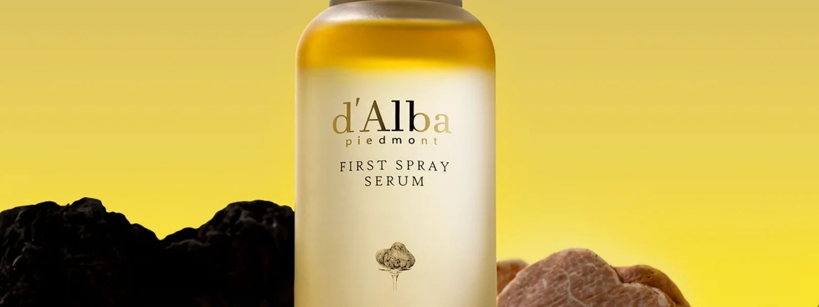 d'Alba First Spray Serum bottle with truffles on a yellow background