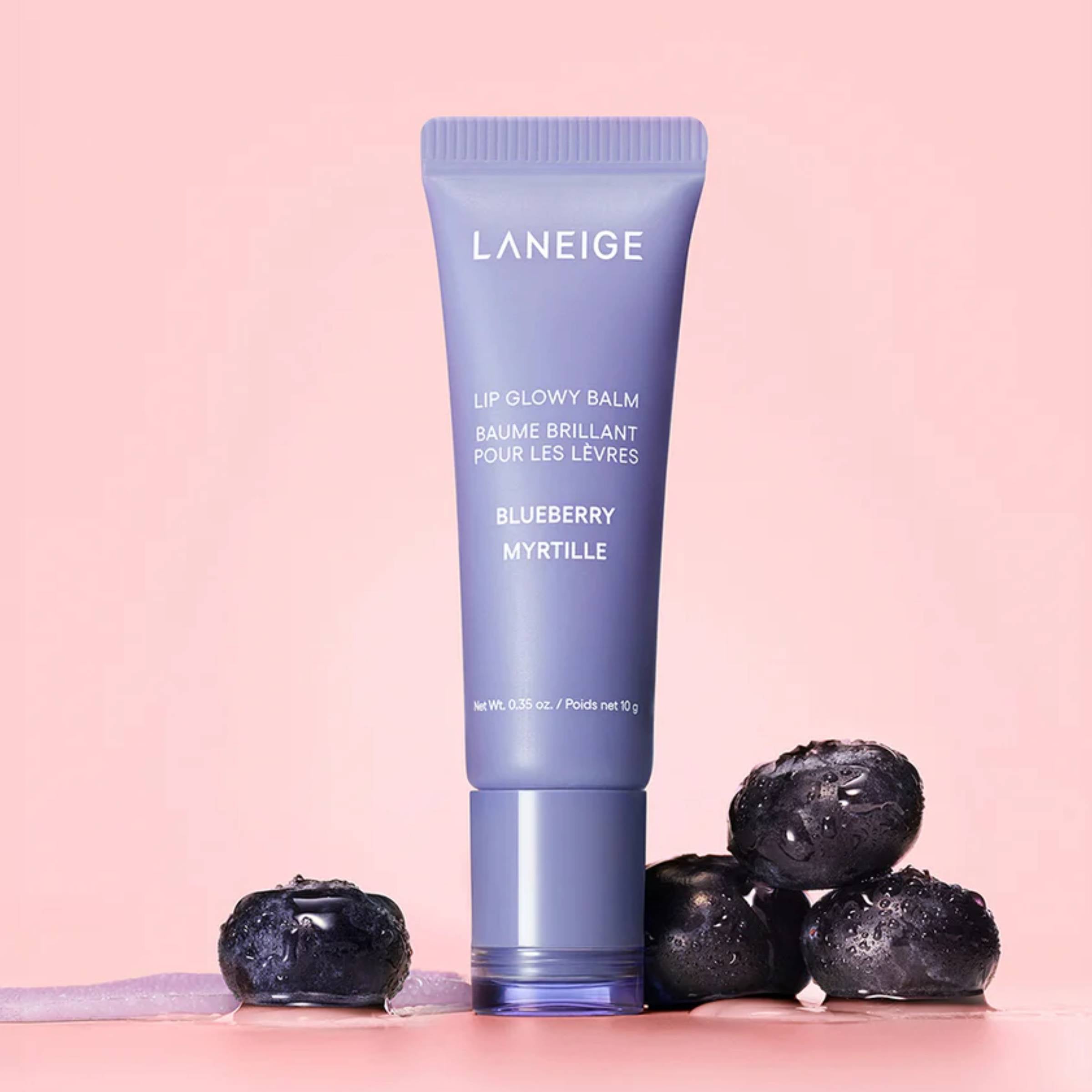 Laneige lip balm tube with blueberries on a pink background