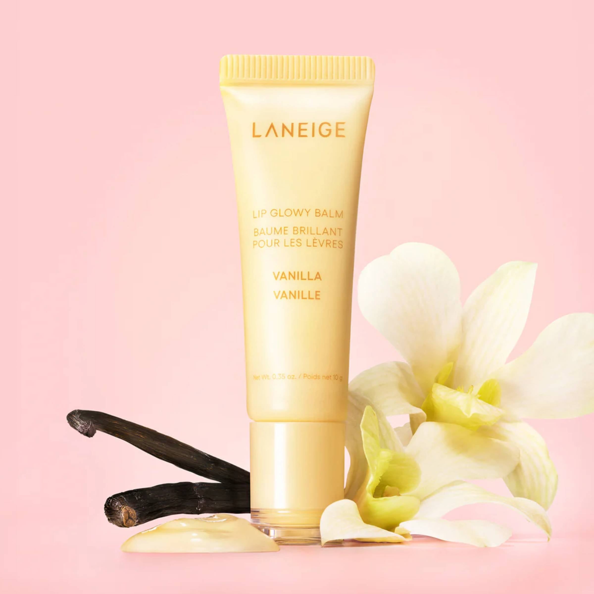 Laneige lip balm with vanilla beans and flowers on a pink background
