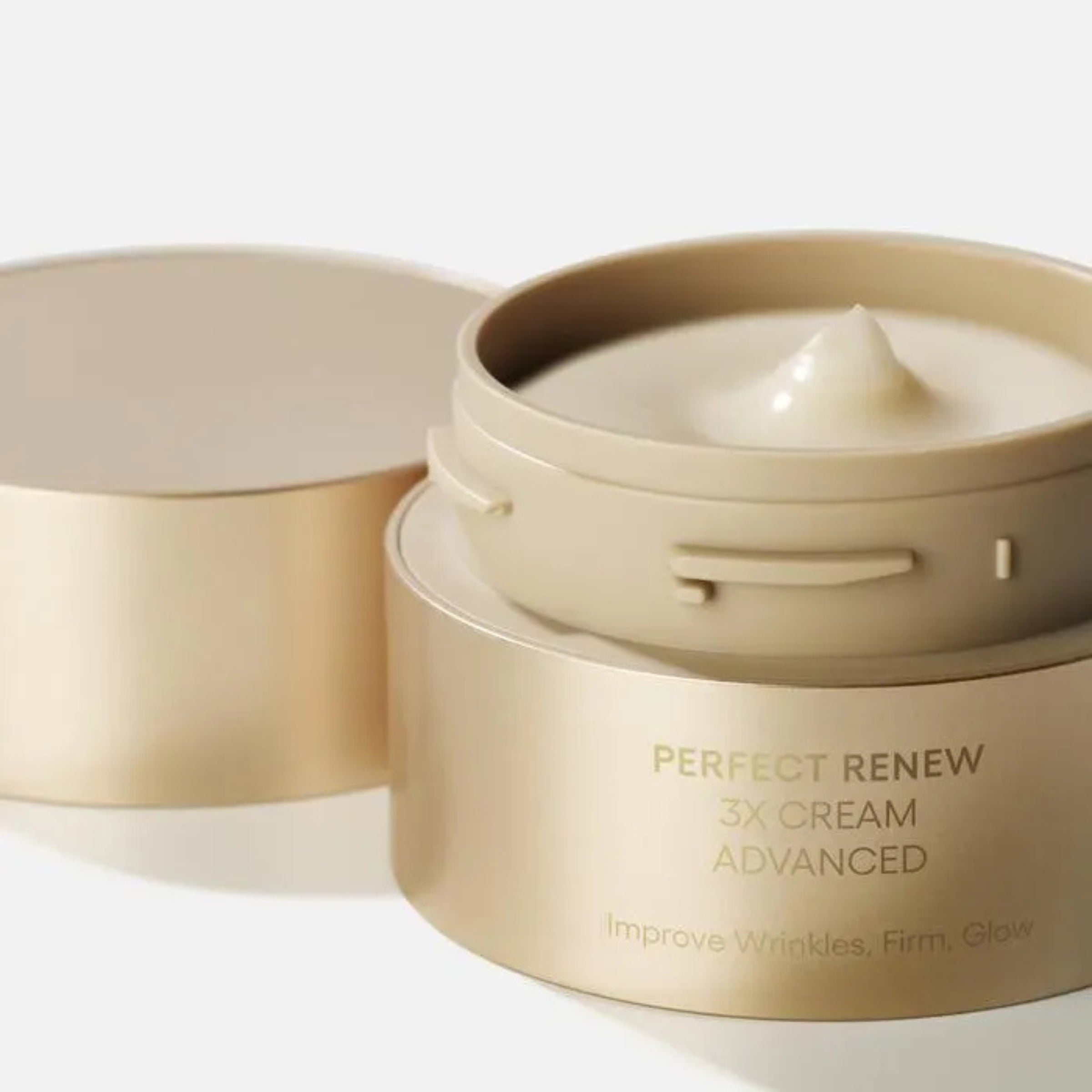 Beige skincare cream jar with 'Perfect Renew' text on a white background