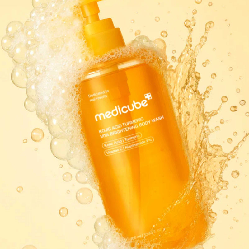Orange bottle of Medicube body wash with bubbles and water splash on a yellow background