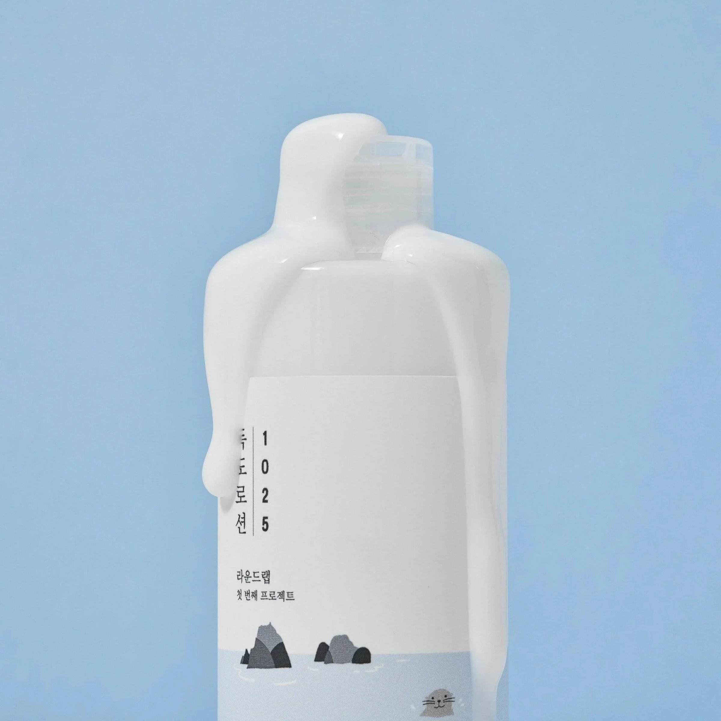 White bottle with text and design on a light blue background