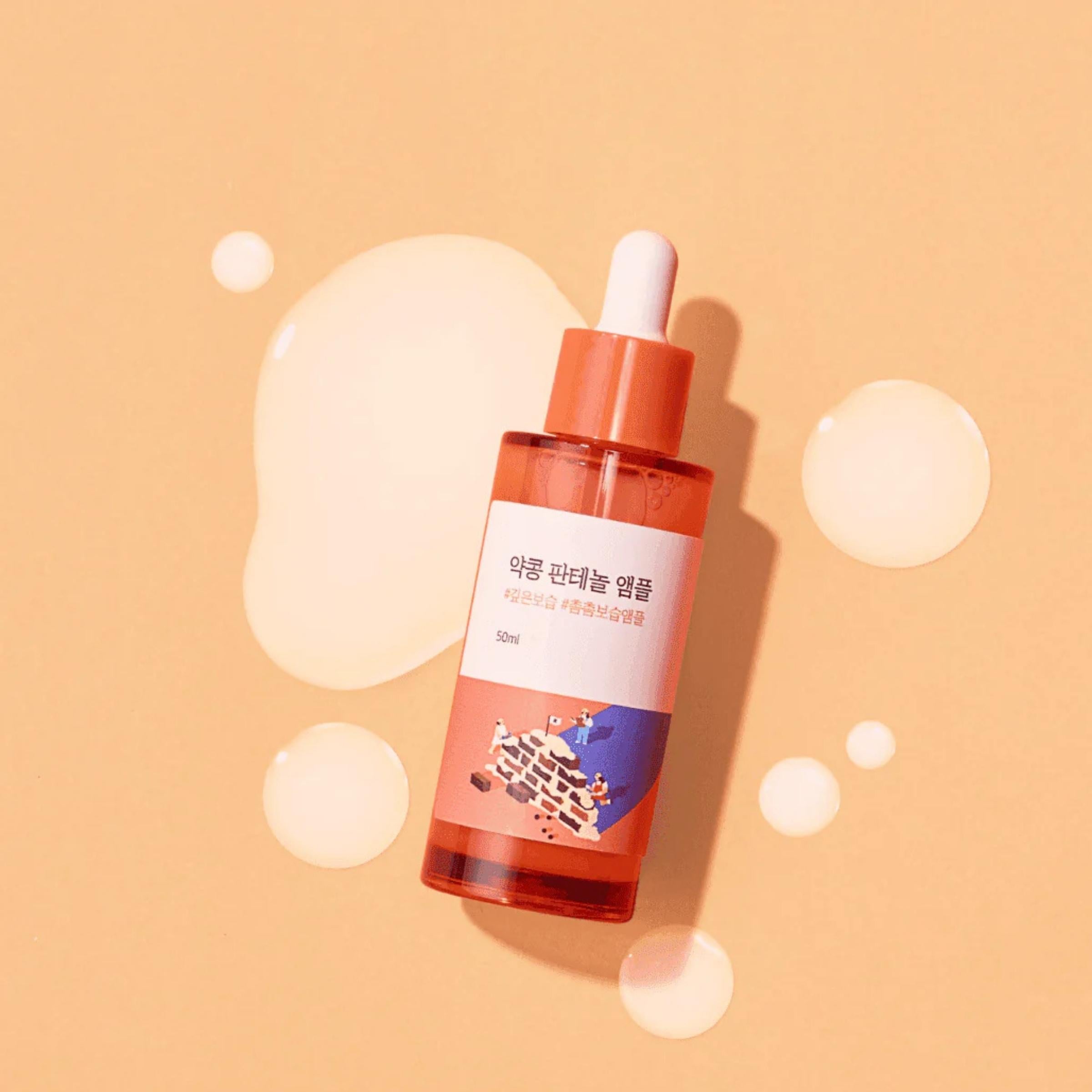 Skincare serum bottle with dropper on a beige background