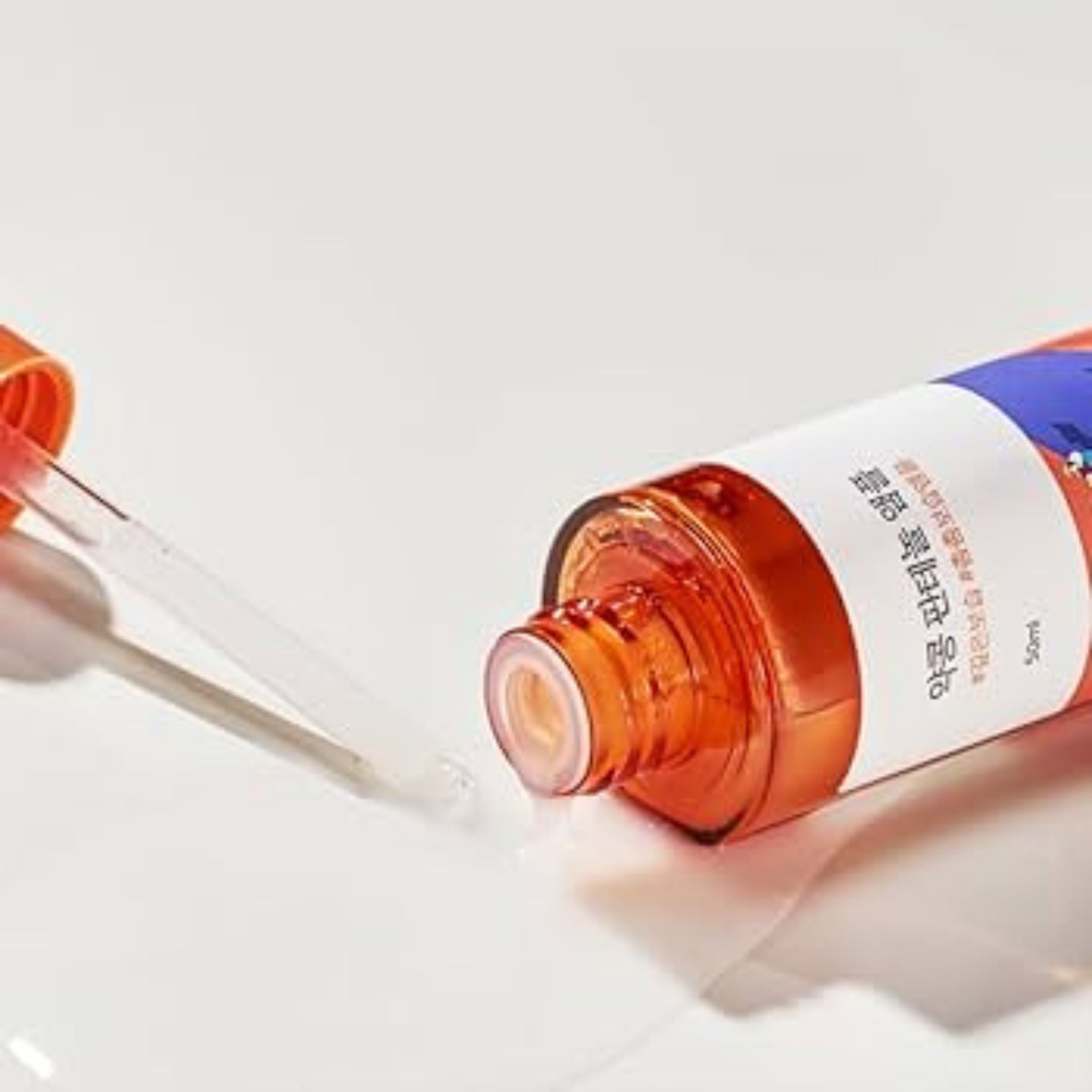 Bottle of eye drops with a dropper on a white background