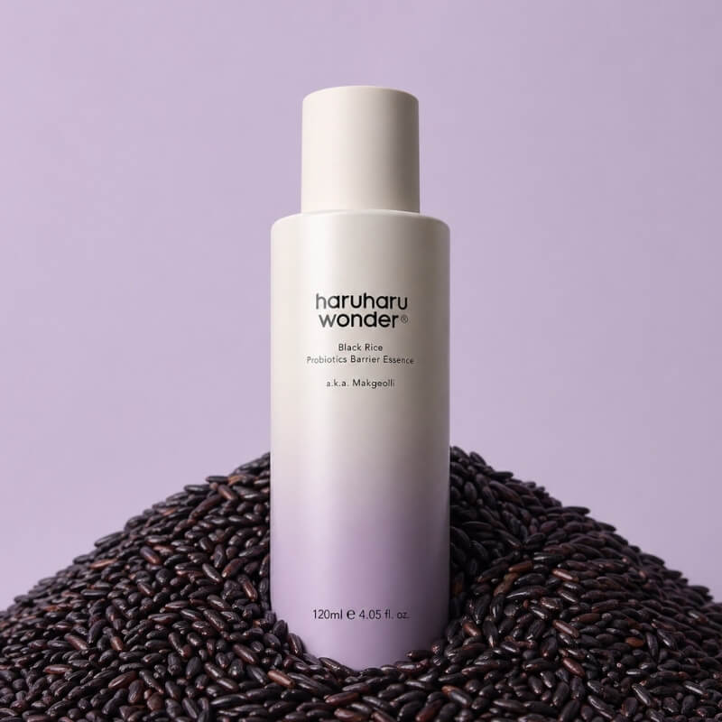 Haruharu Wonder bottle on a bed of black rice against a purple background