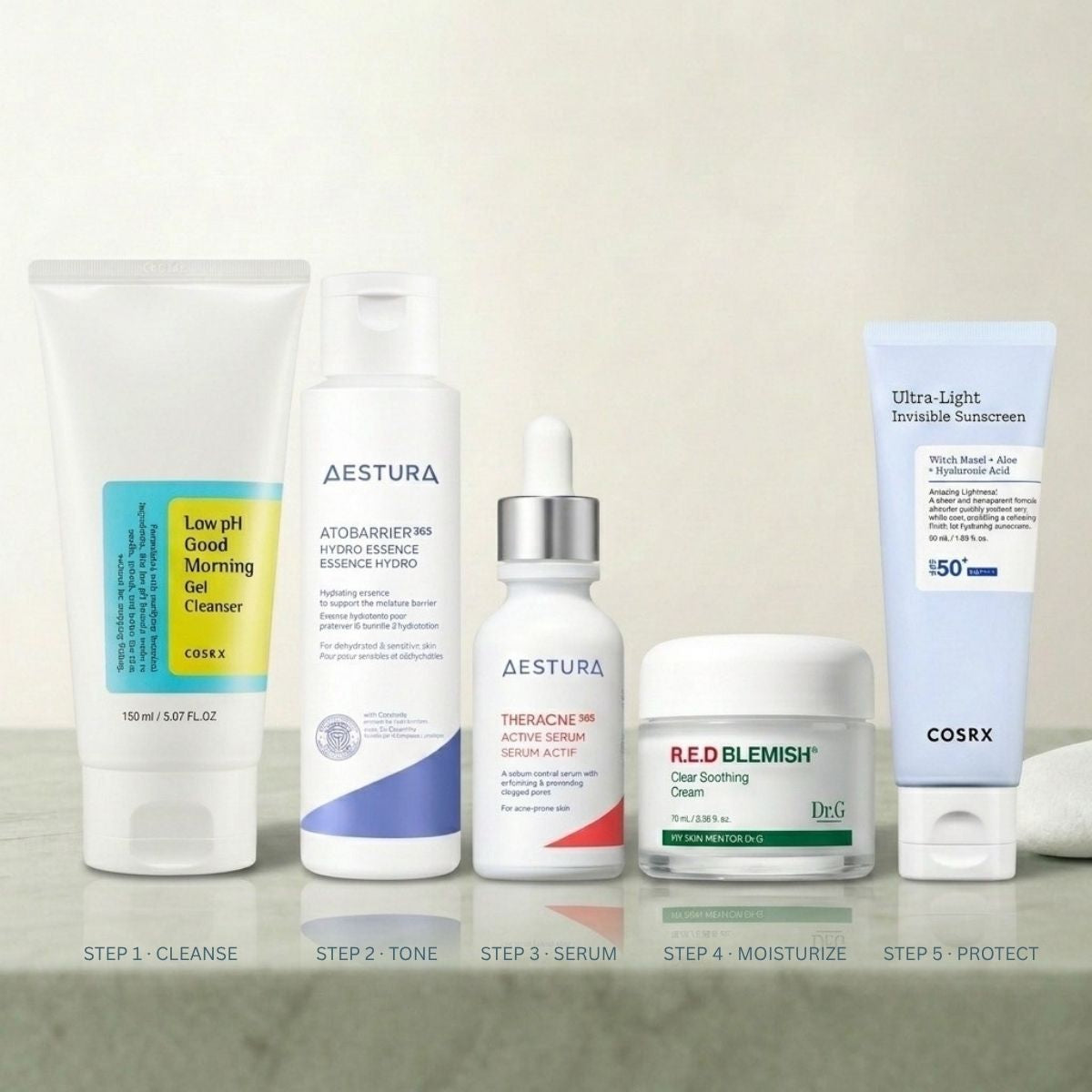 Korean skincare products for acne clearing routine on marble surface