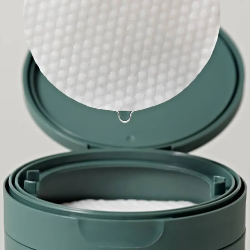 ANUA Heartleaf 77 Clear Pad container with a lid open, revealing white cotton pads inside.
