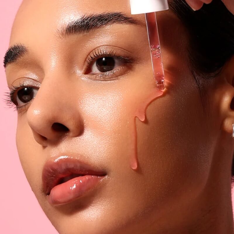 Close-up of a woman applying ANUA Niacinamide 10% + TXA 4% Dark Spot Correcting Serum