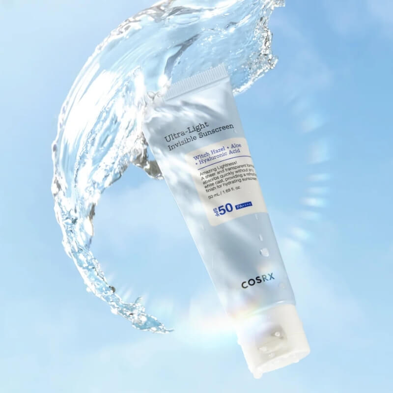 COSRX Ultra Light Invisible Sunscreen with water splash on a light blue background