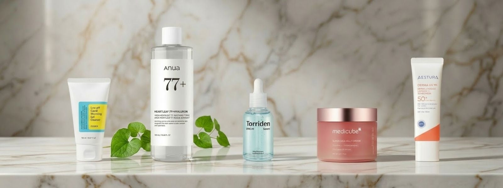 Row of korean skincare products on a marble surface