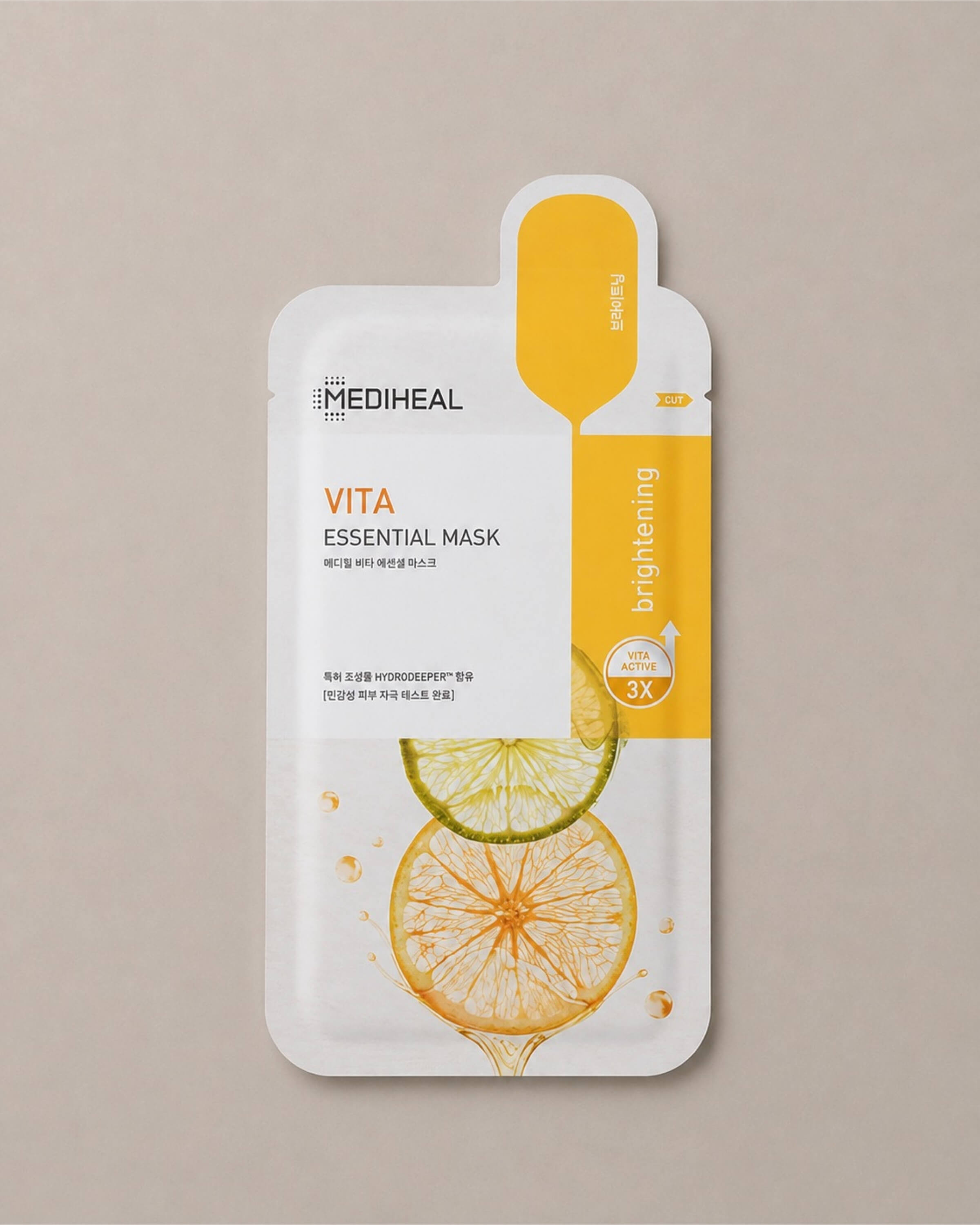 Mediheal Vita Essential Mask with lemon and lime design on a beige background