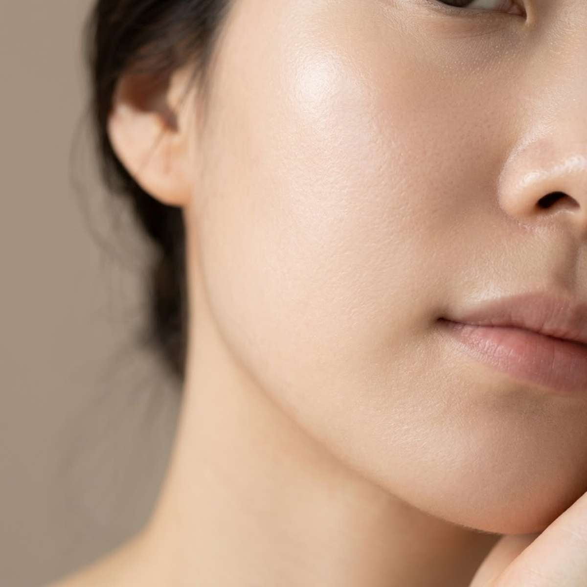 close-up of womans face with natural skin texture showing refined pores and smooth complexion