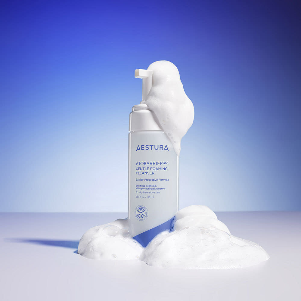 Aestura skincare product with foam on a blue gradient background