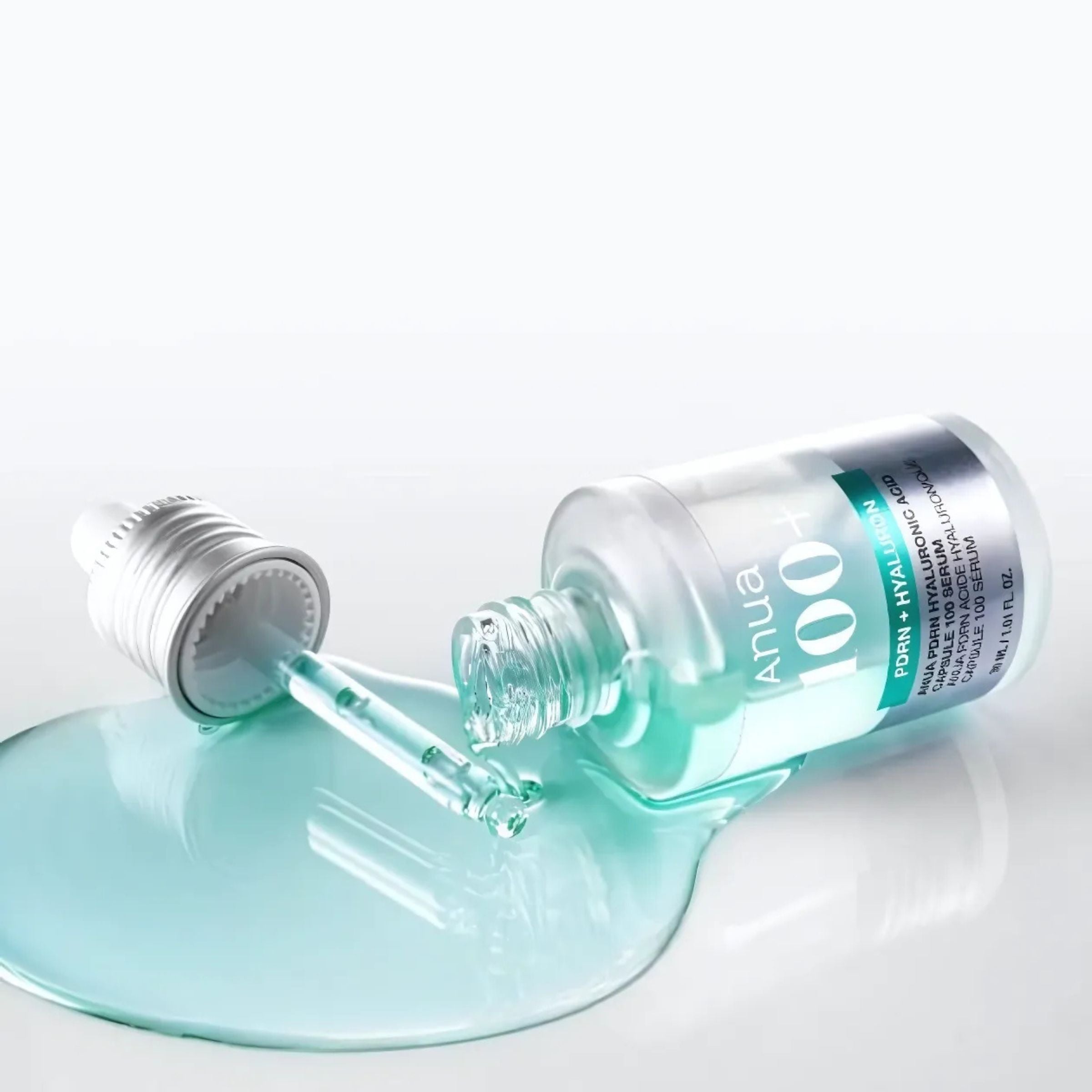 Bottle of skincare product with dropper on a white background