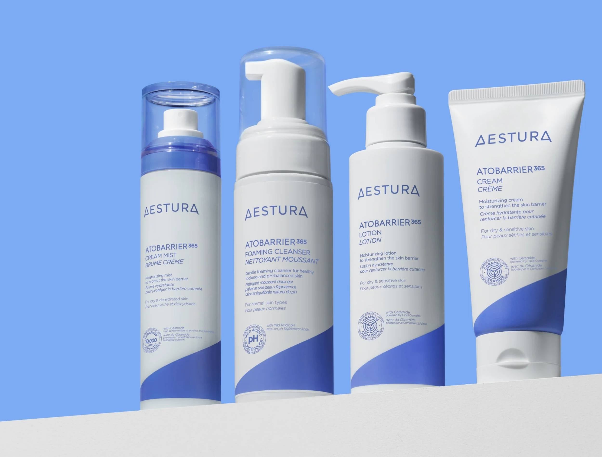 Aestura skincare products on a white surface with a blue background