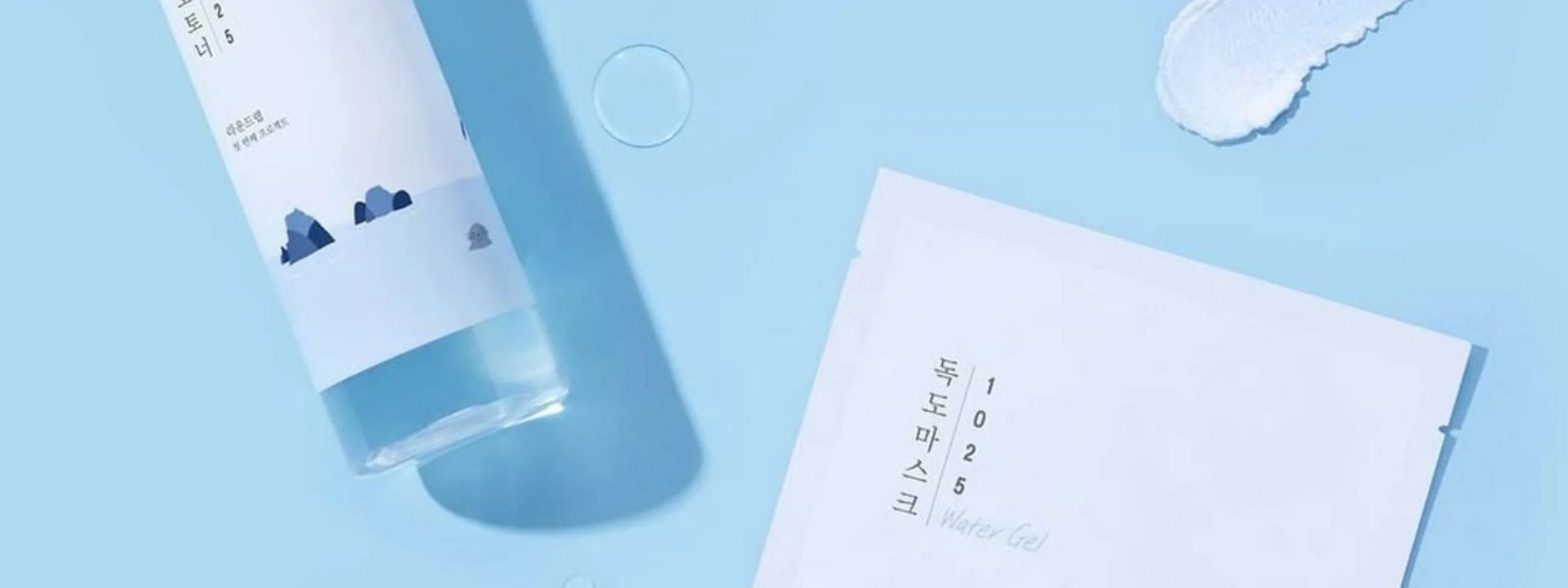 Round Lab skincare product with a droplet on a blue background