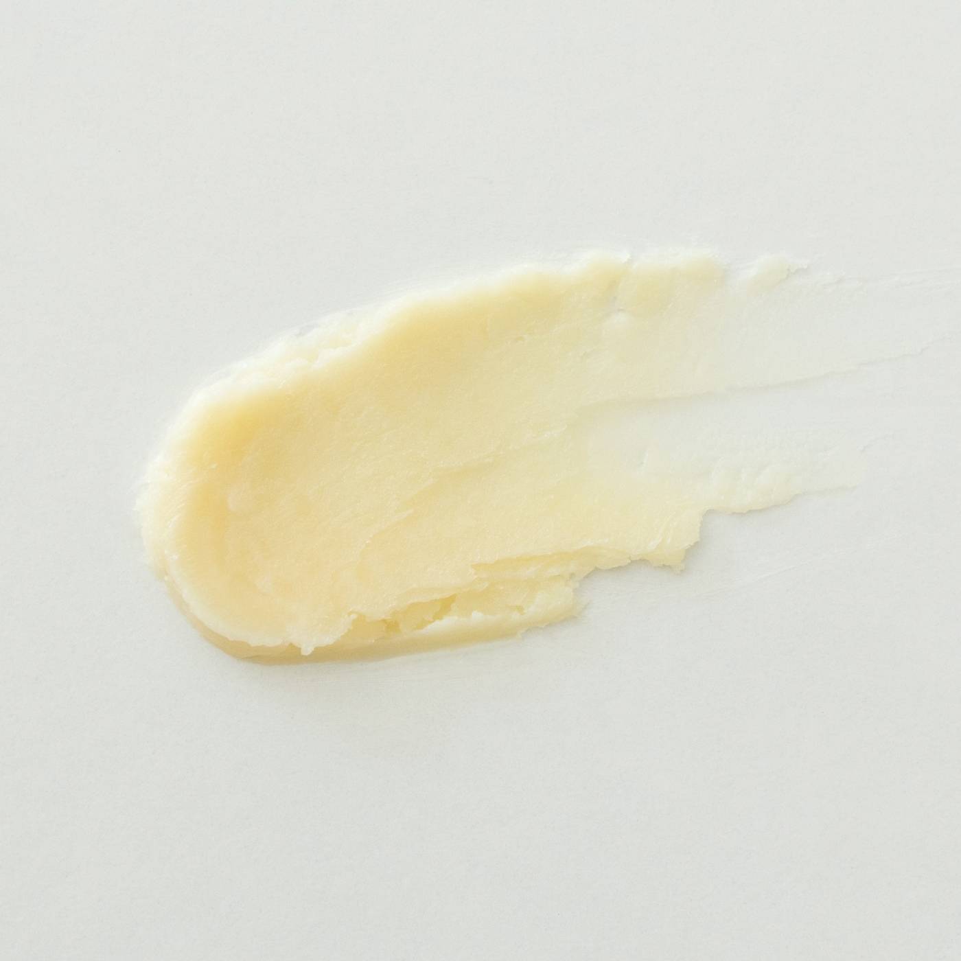 Yellow cleansing balm on a white background