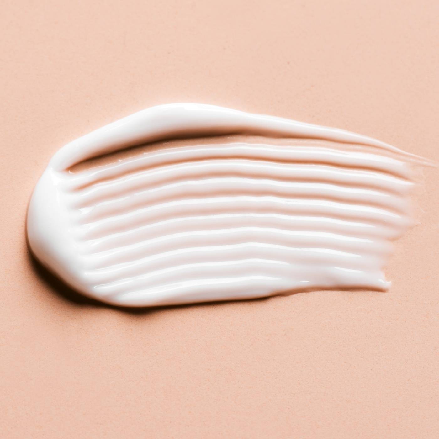 White cleansing cream on a peach background