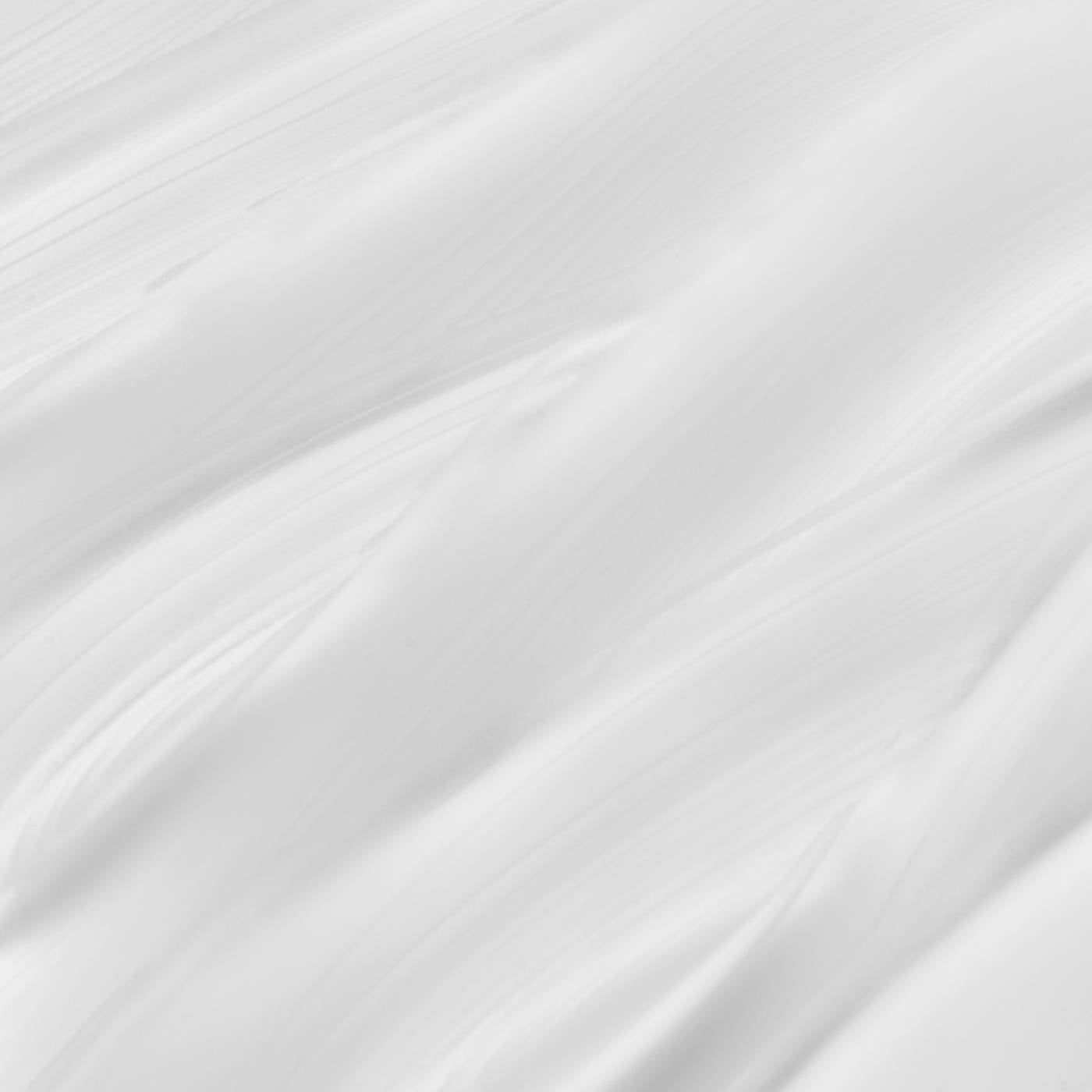 Close-up of white eye cream with subtle texture