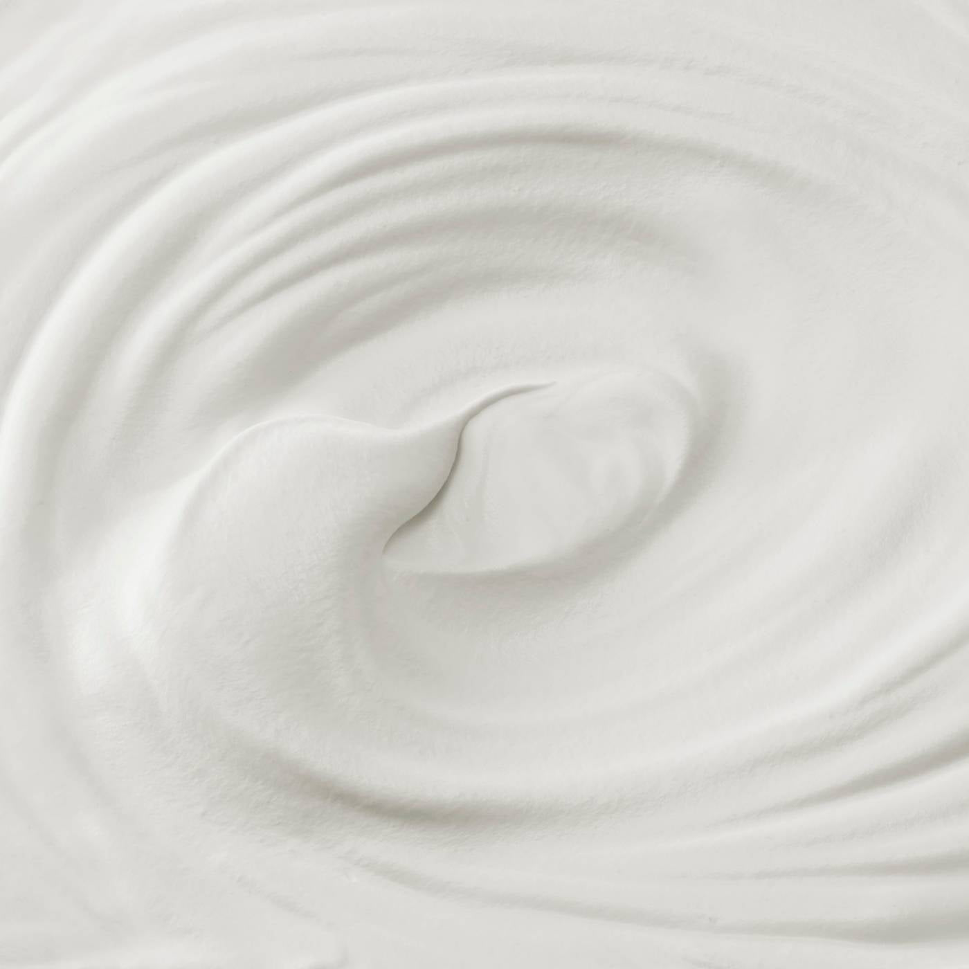 Close-up of white moisturizer cream with a swirl texture