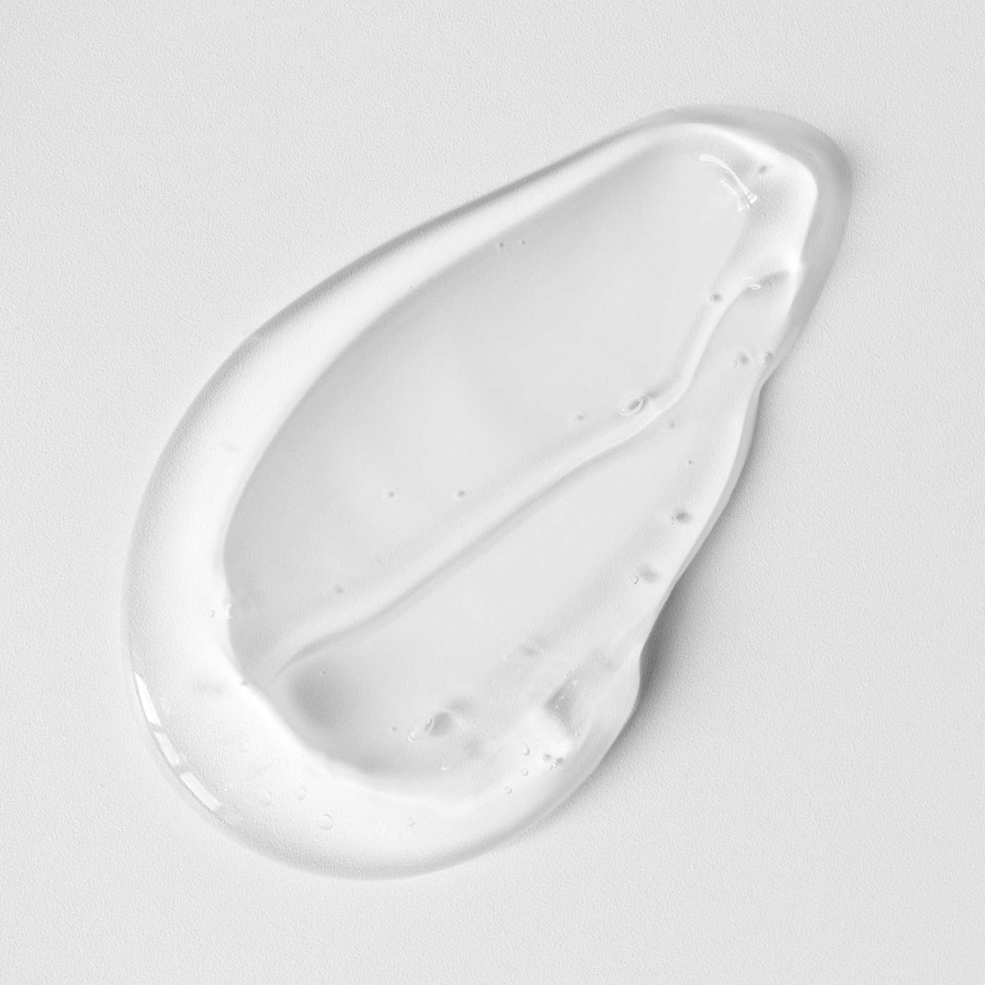 Gel suncream smear on a light gray background