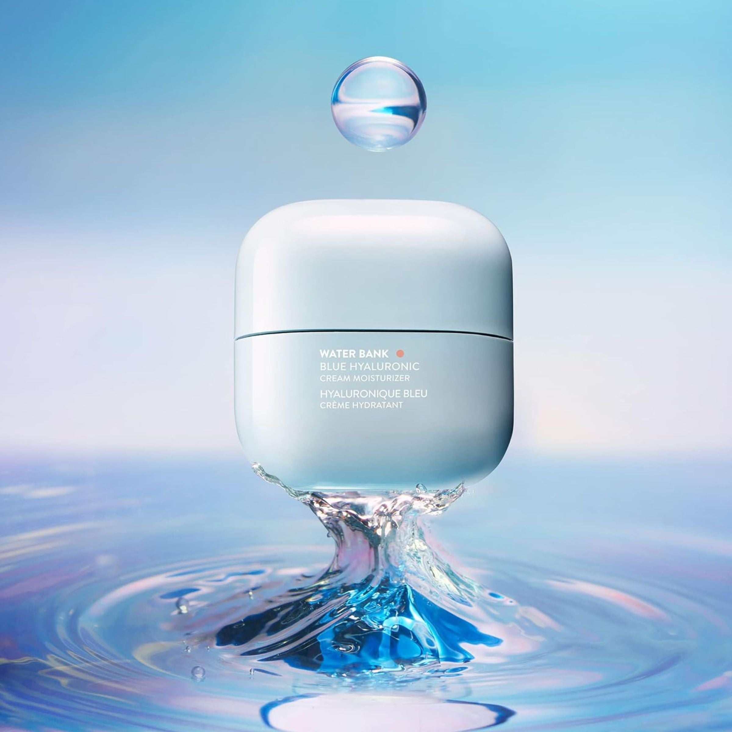Skincare product with water droplet and ripples on a blue gradient background
