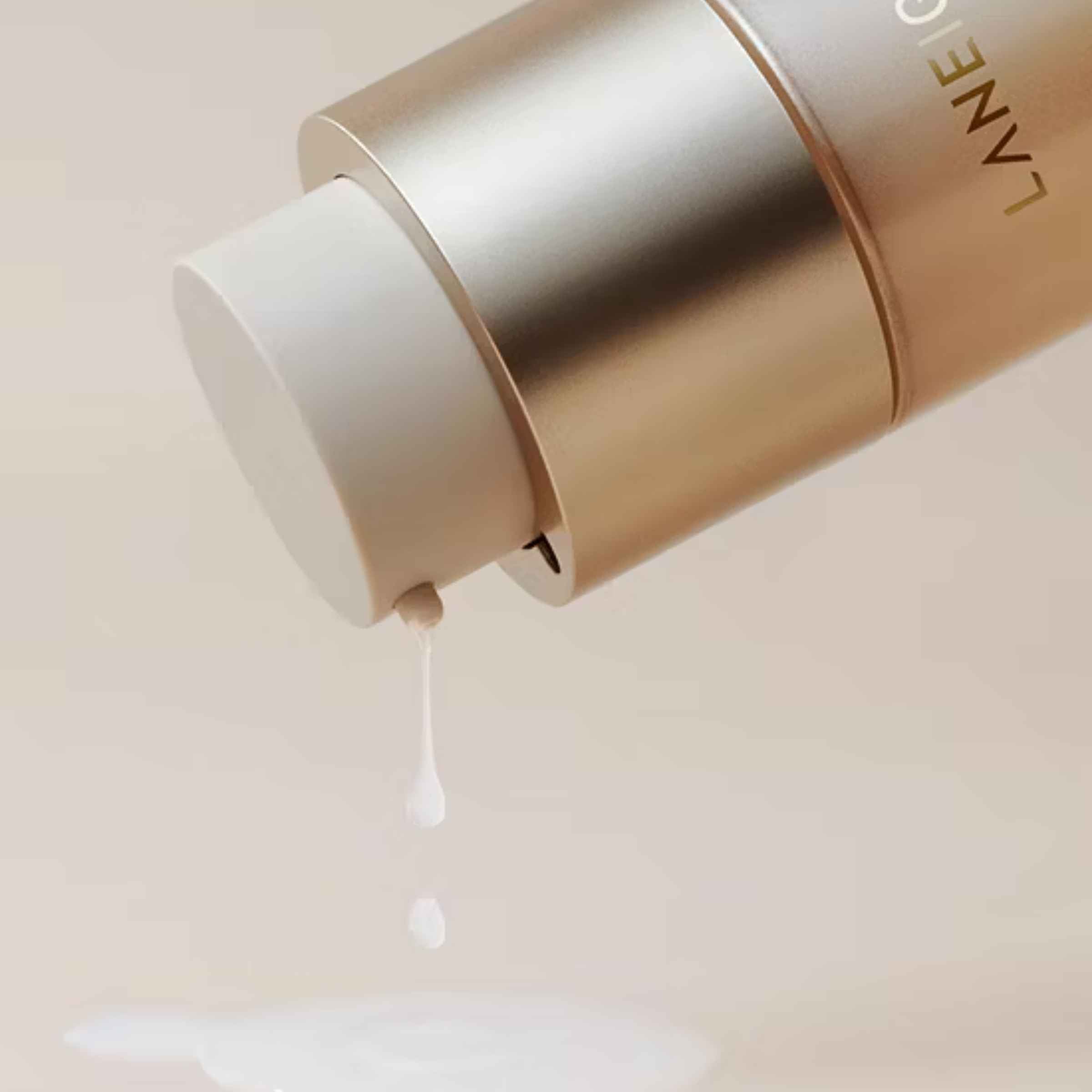 Laneige skincare product with cream dripping from the applicator on a light background