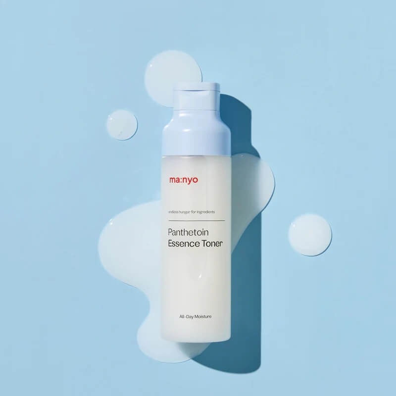Manyo Panthetoin Essence Toner with toner texture on blue background
