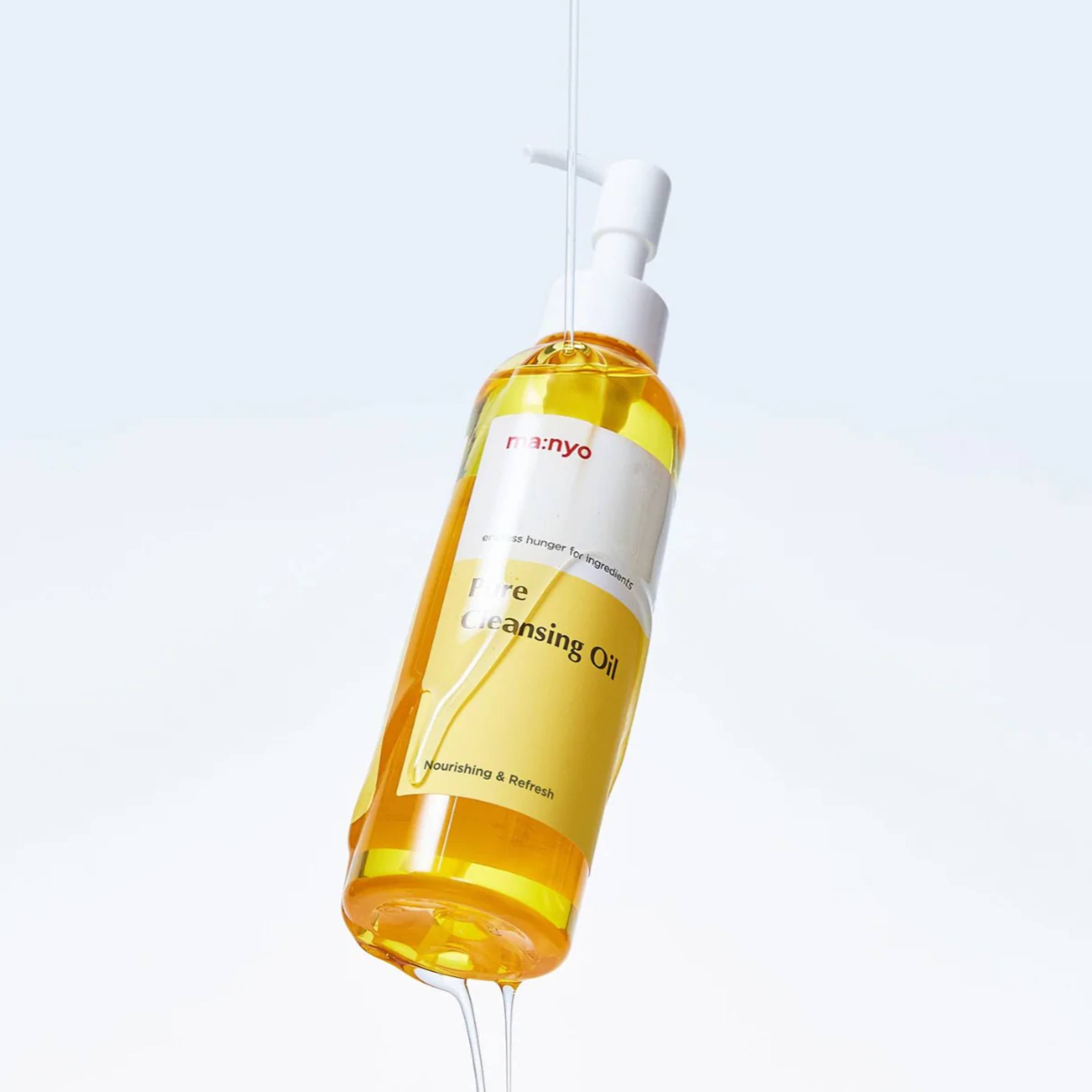 Bottle of cleansing oil with a pump on a light gray background