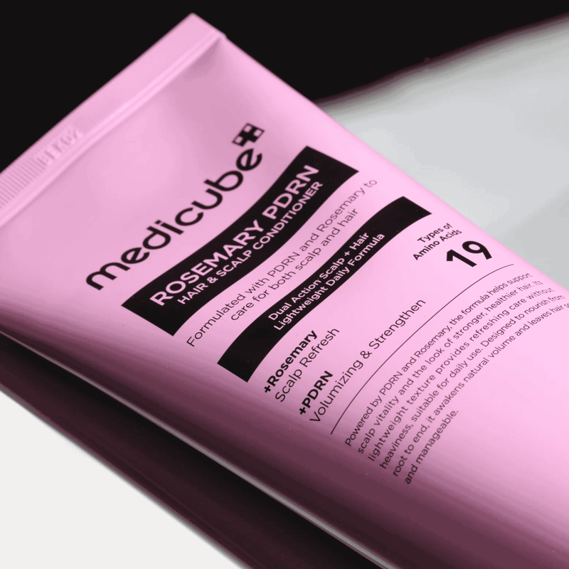 Pink packaging of Medicube Rosemary PDRN hair and scalp conditioner on a white background