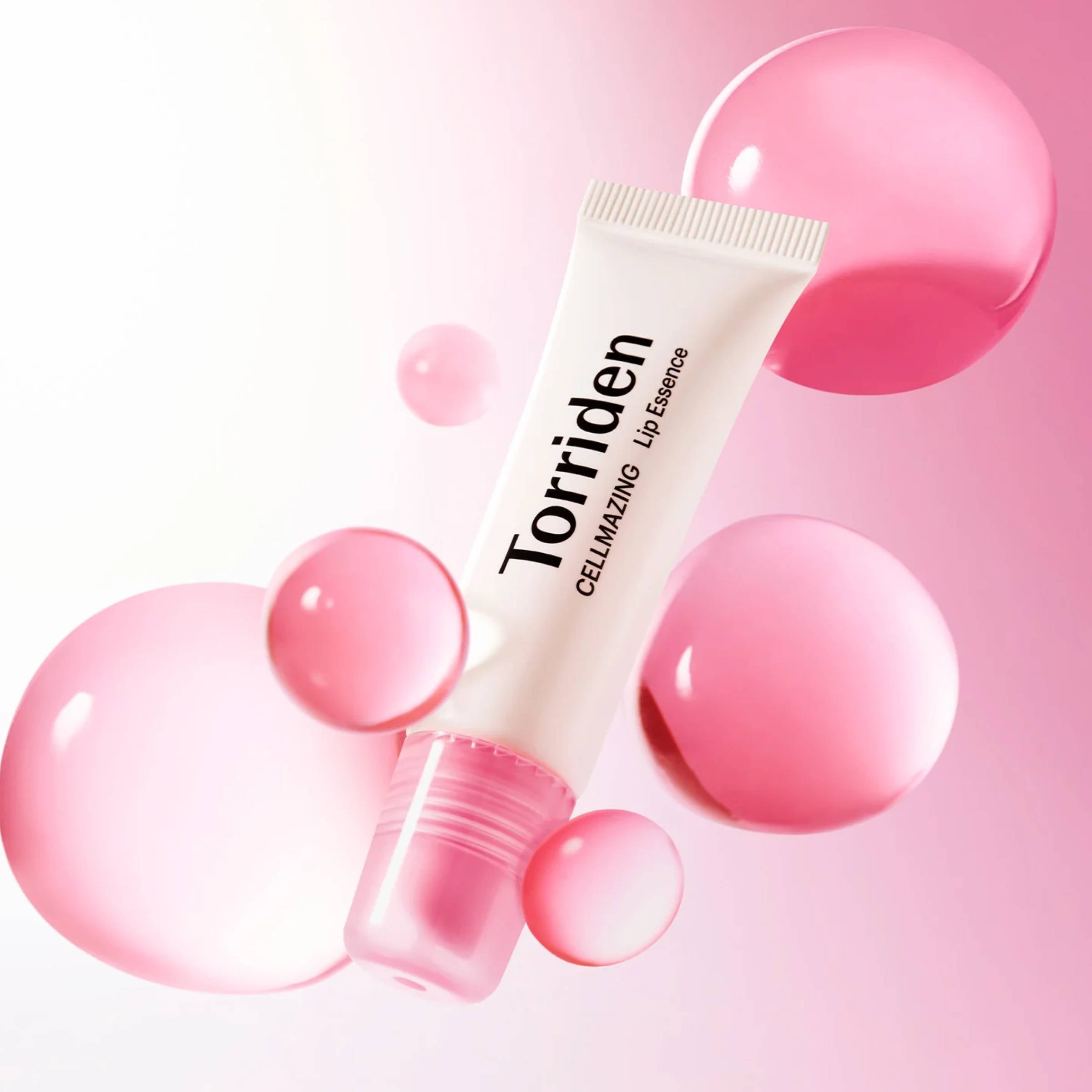 Torriden lip essence tube with pink bubbles on a pink background