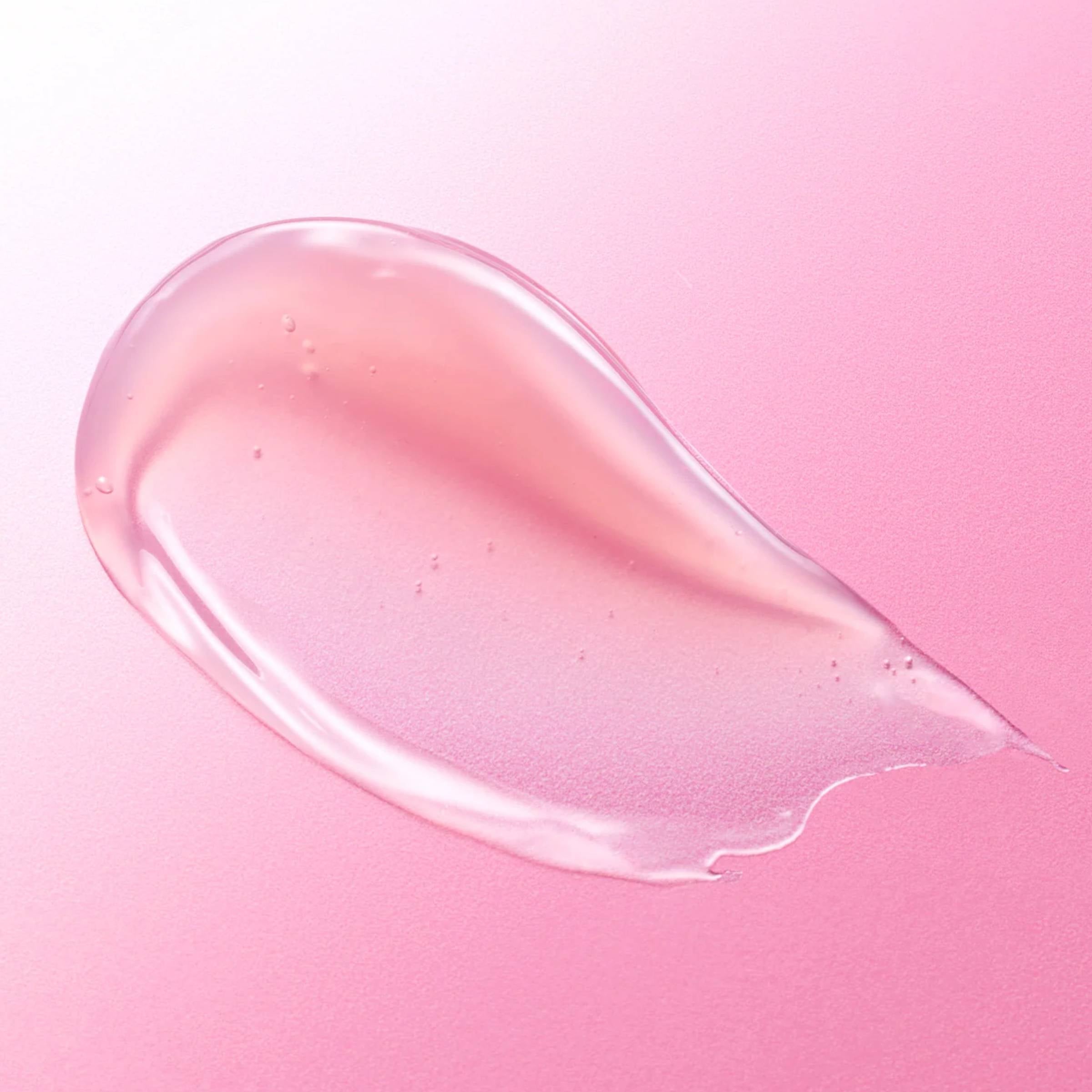 Pink skincare product smear on a pink background