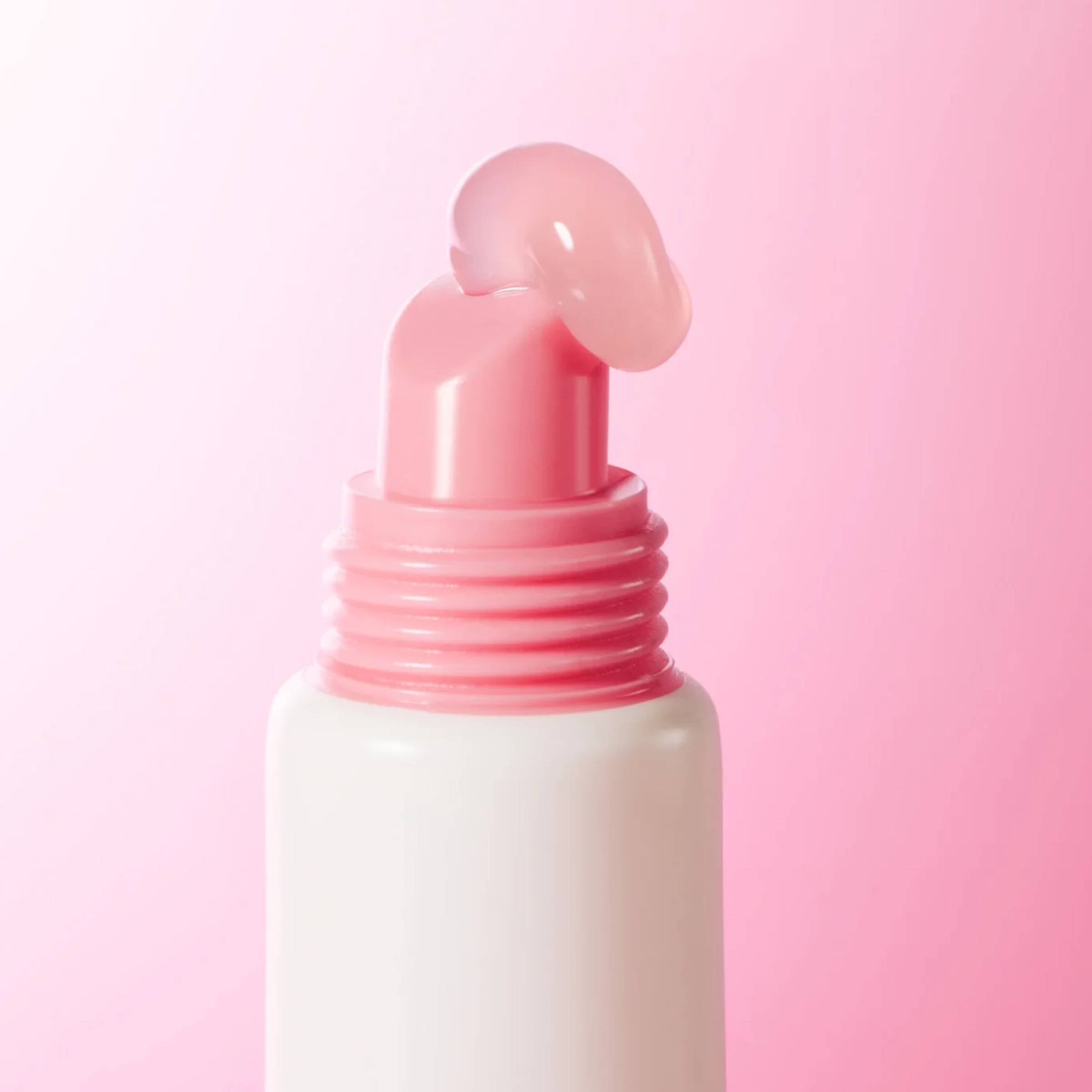 Pink dropper bottle on a pink background