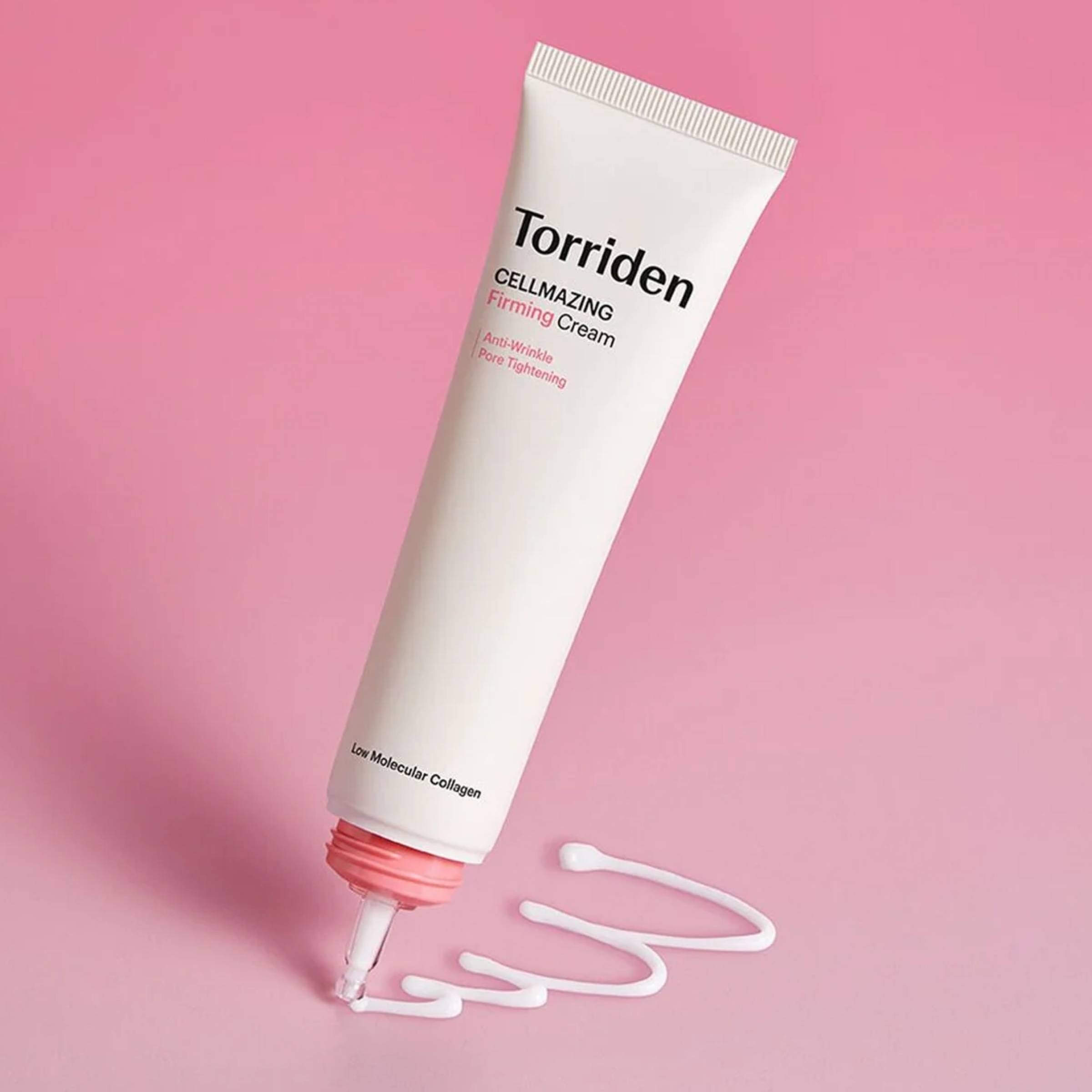 Torriden firming cream tube on a pink background