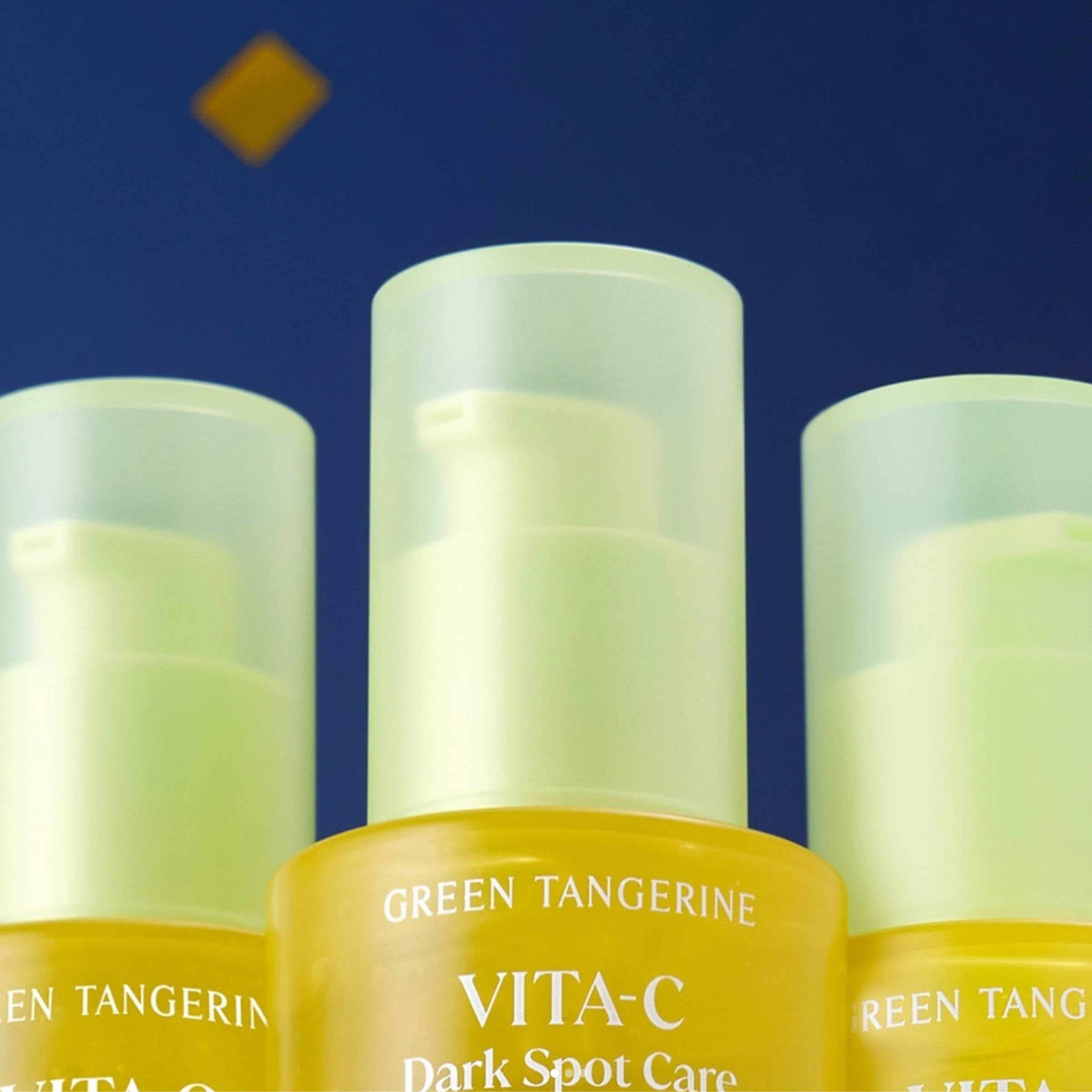 Three skincare bottles with 'Green Tangerine' branding on a blue background