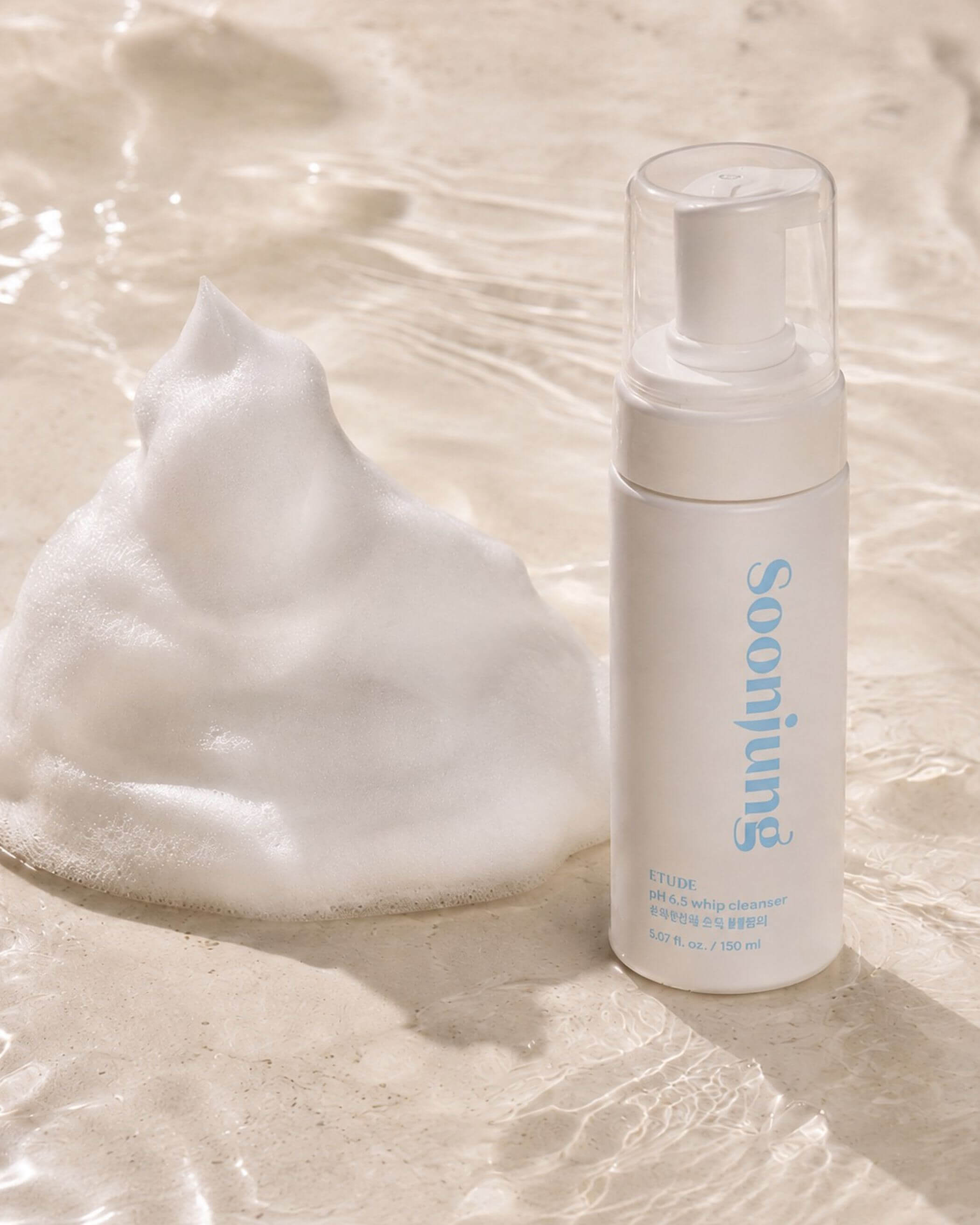 Etude SoonJung pH 6.5 Whip Cleanser on a textured beige background