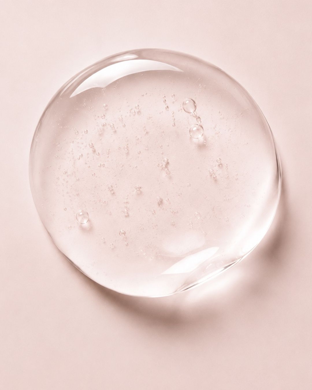 Clear PDRN with air bubbles on a pink background