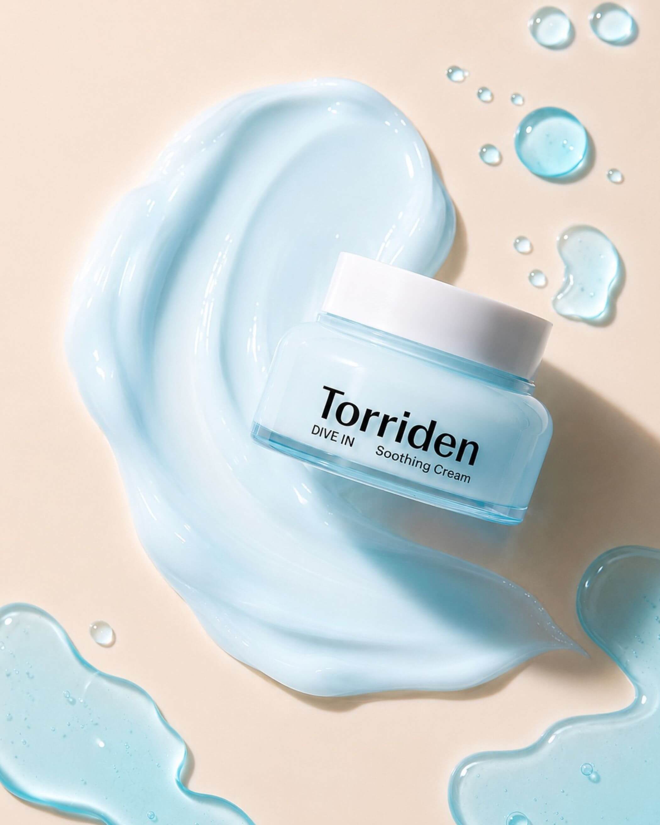 Torriden soothing cream jar with blue cream on a beige background