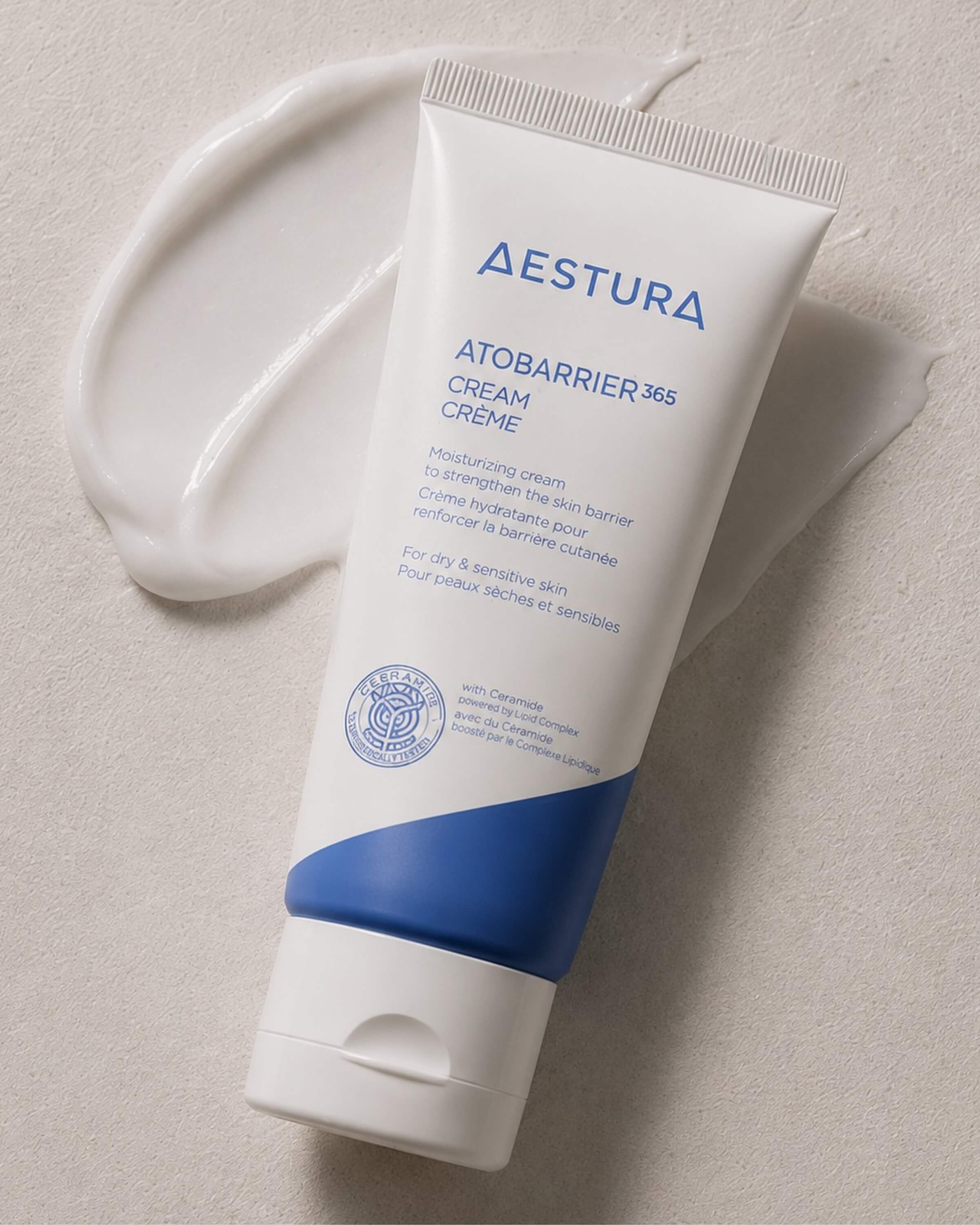 Aestura Atobarrier 365 Cream tube on a beige background with white cream 