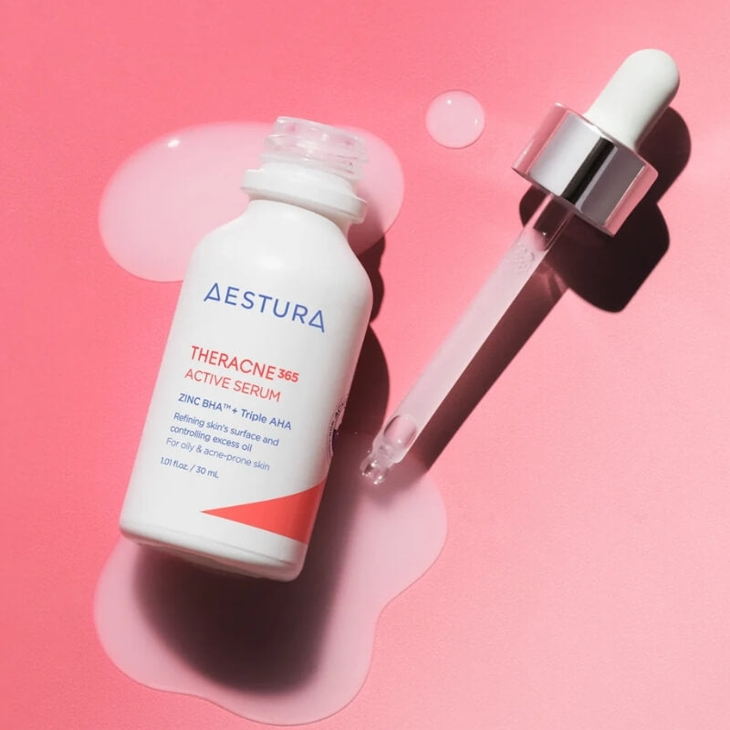 Aestura Theracne 365 Active Serum bottle with dropper on a pink background