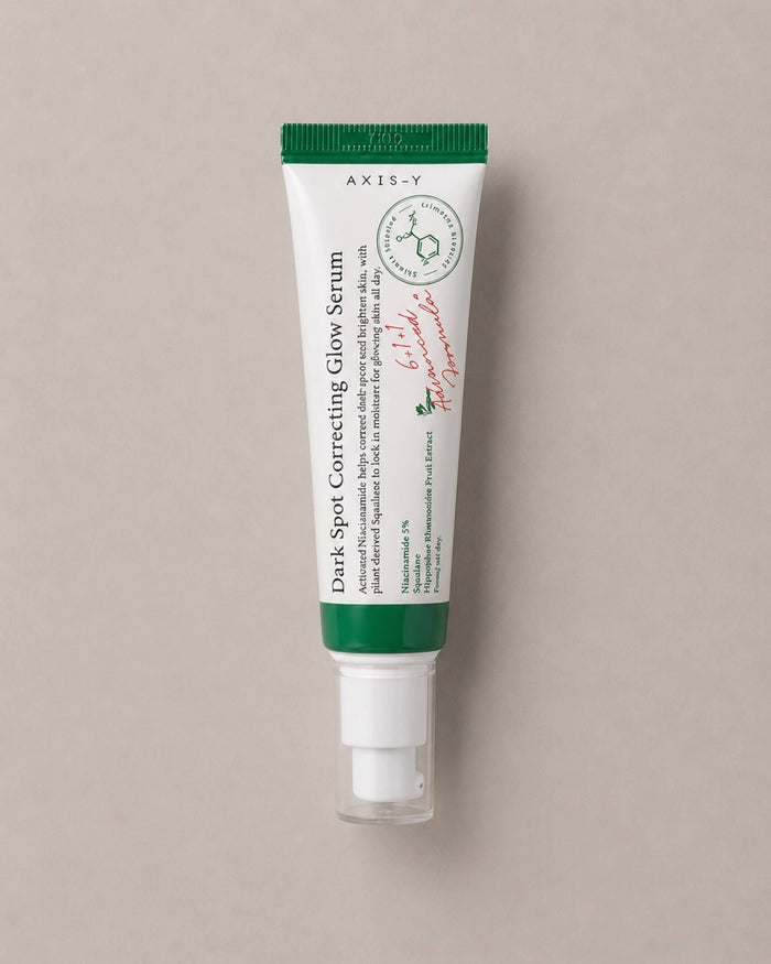 Tube of Axis-Y Dark Spot Correcting Glow Serum on a beige background