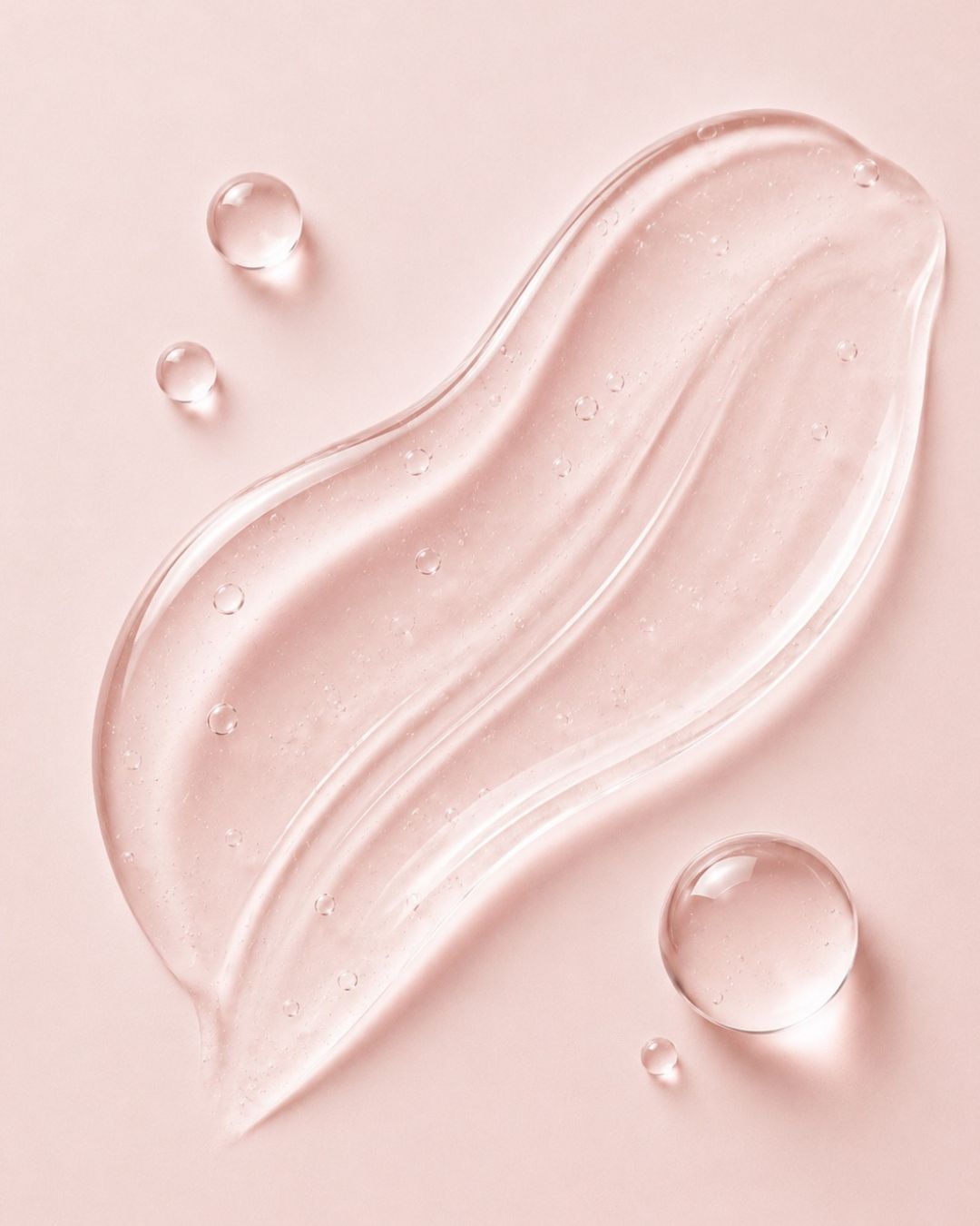 Collagen gel on a pink background with droplets