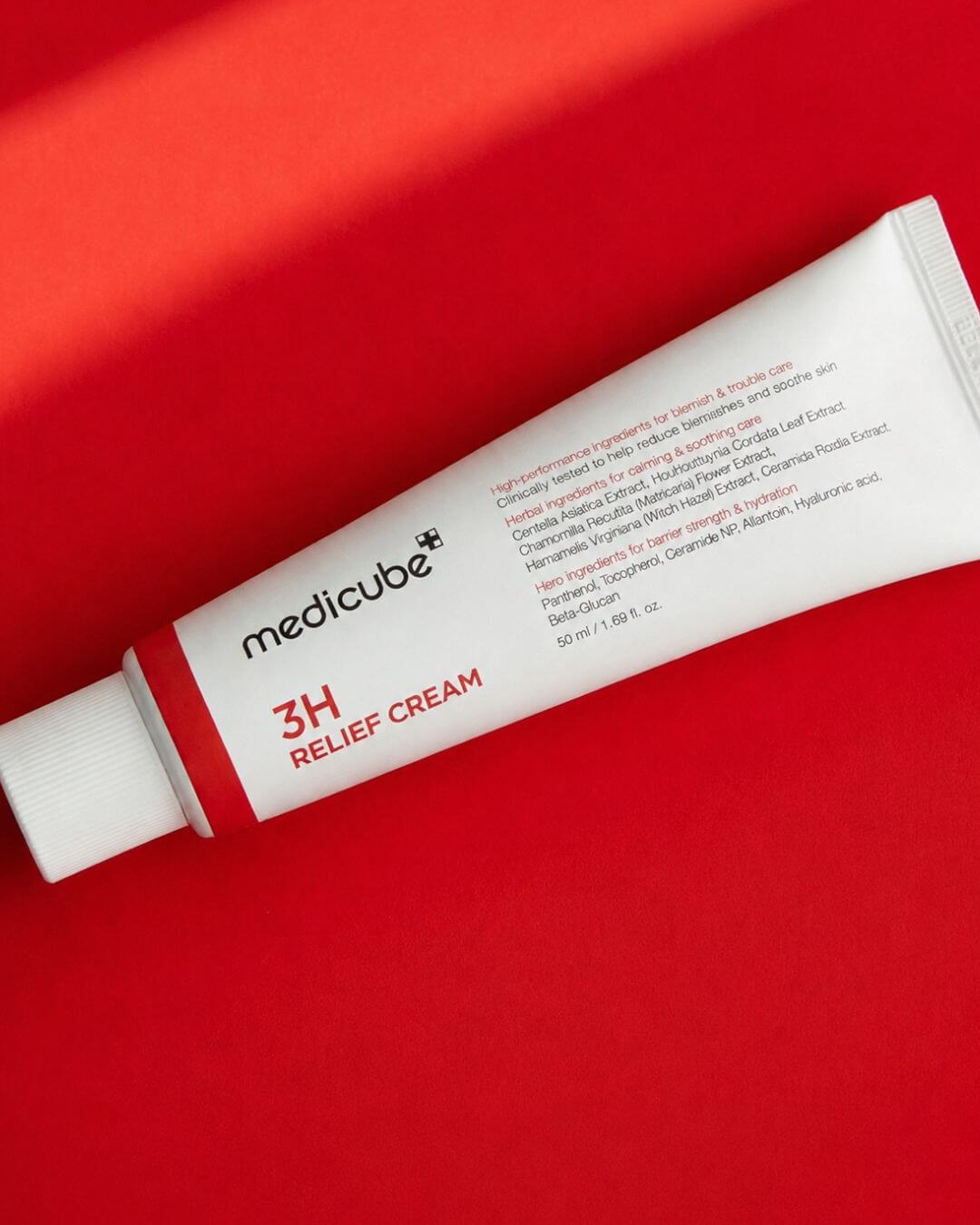 Tube of Medicube 3H Relief Cream on a red background